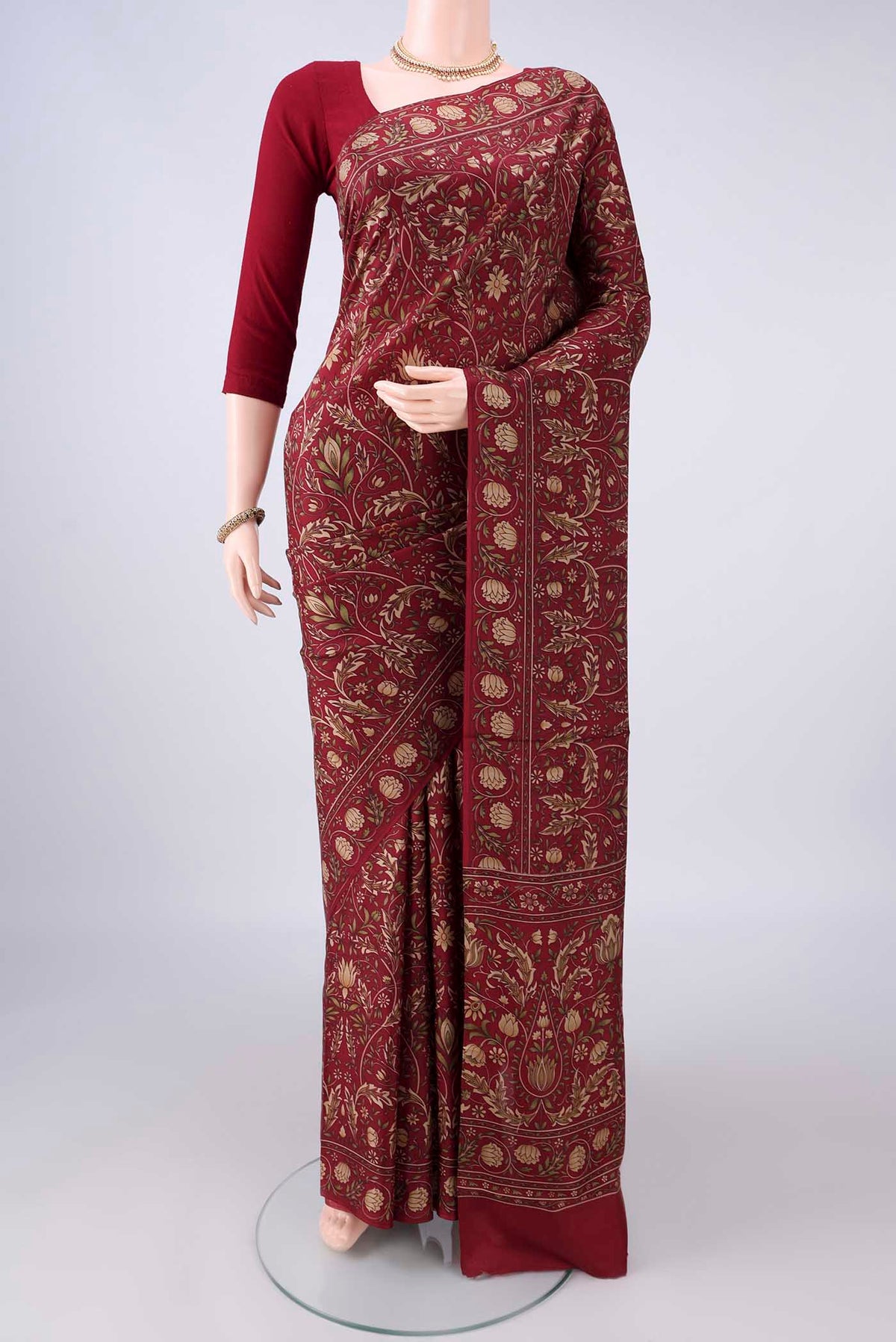 Pure Silk Maroon Printed Saree with Printed design on the body and Printed Border.  displayed on a mannequin