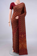 Pure Silk Rust Printed Saree with Printed design on the body and Printed Border.  displayed on a mannequin