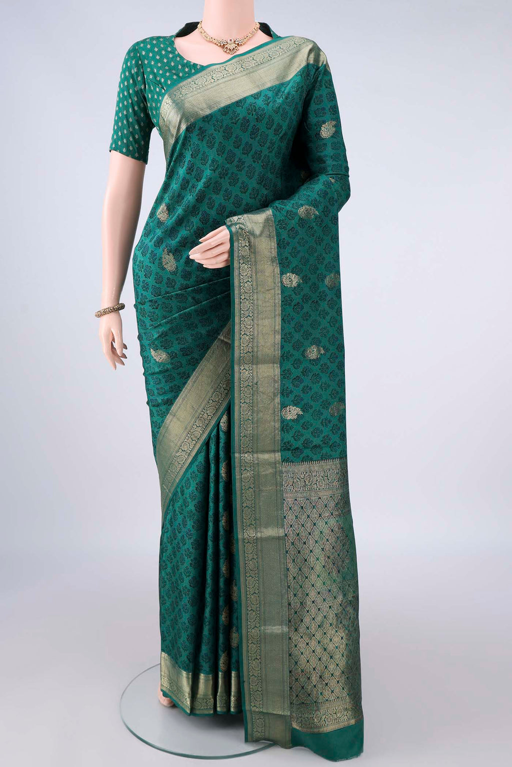 Pure Silk Sea Green Printed Saree with Printed design on the body and Zari Border.  displayed on a mannequin