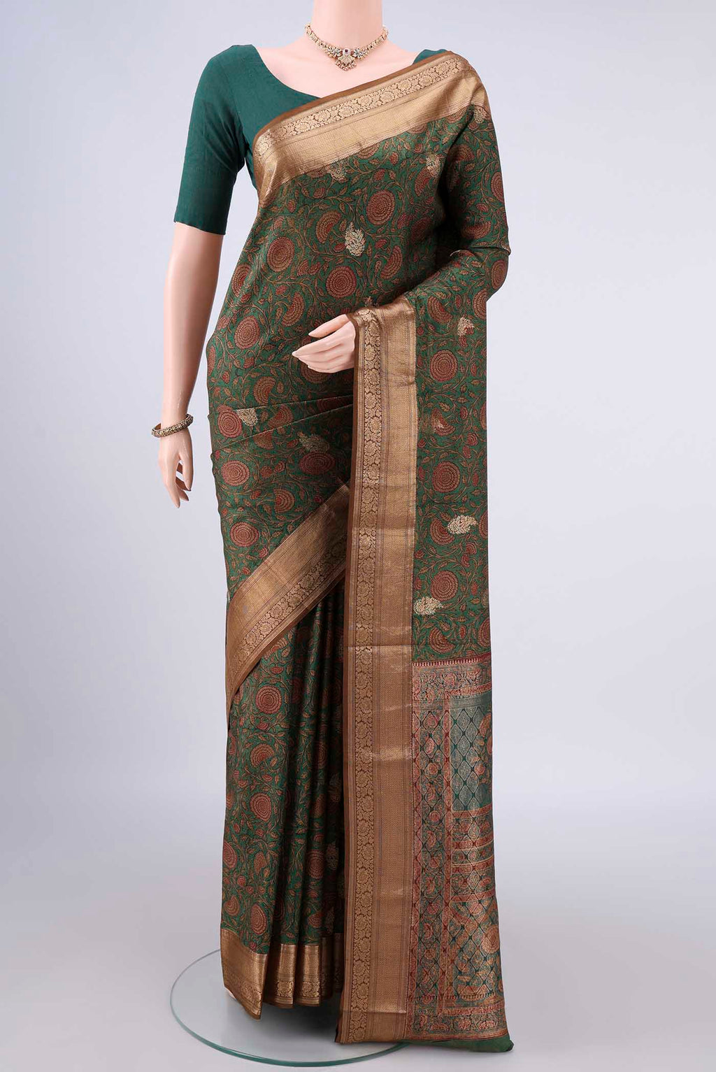 Pure Silk Green Printed Saree with Printed design on the body and Zari Border.  displayed on a mannequin