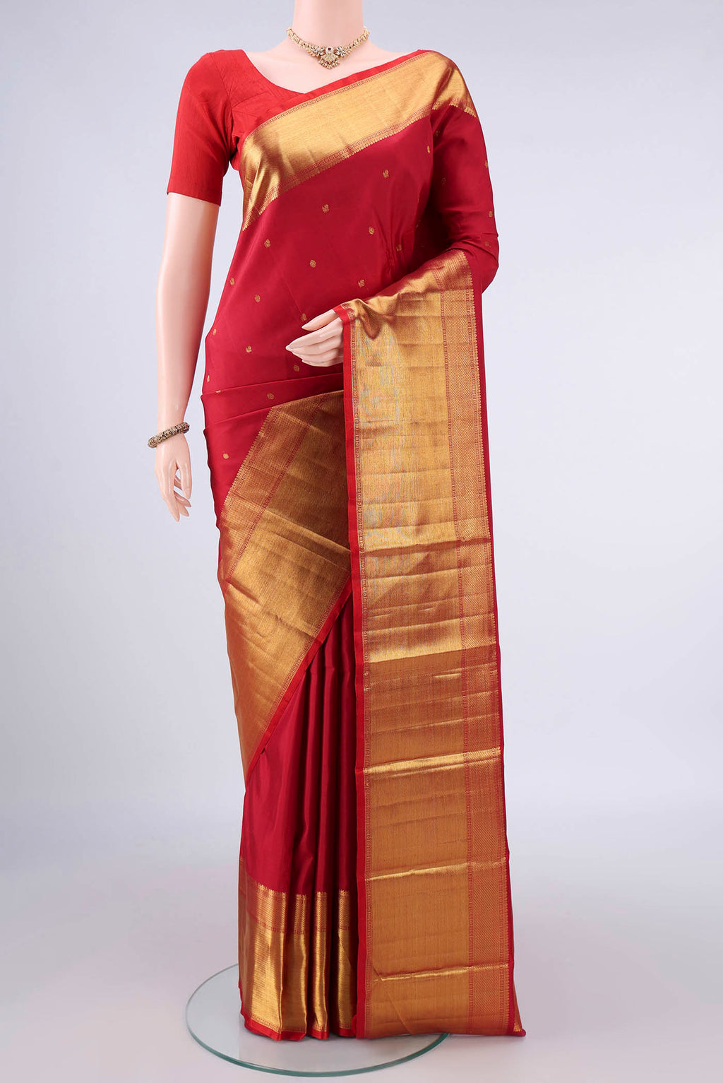 Pure Silk Red Kanchipuram Saree with Zari Butta on the body and Zari Border.  displayed on a mannequin
