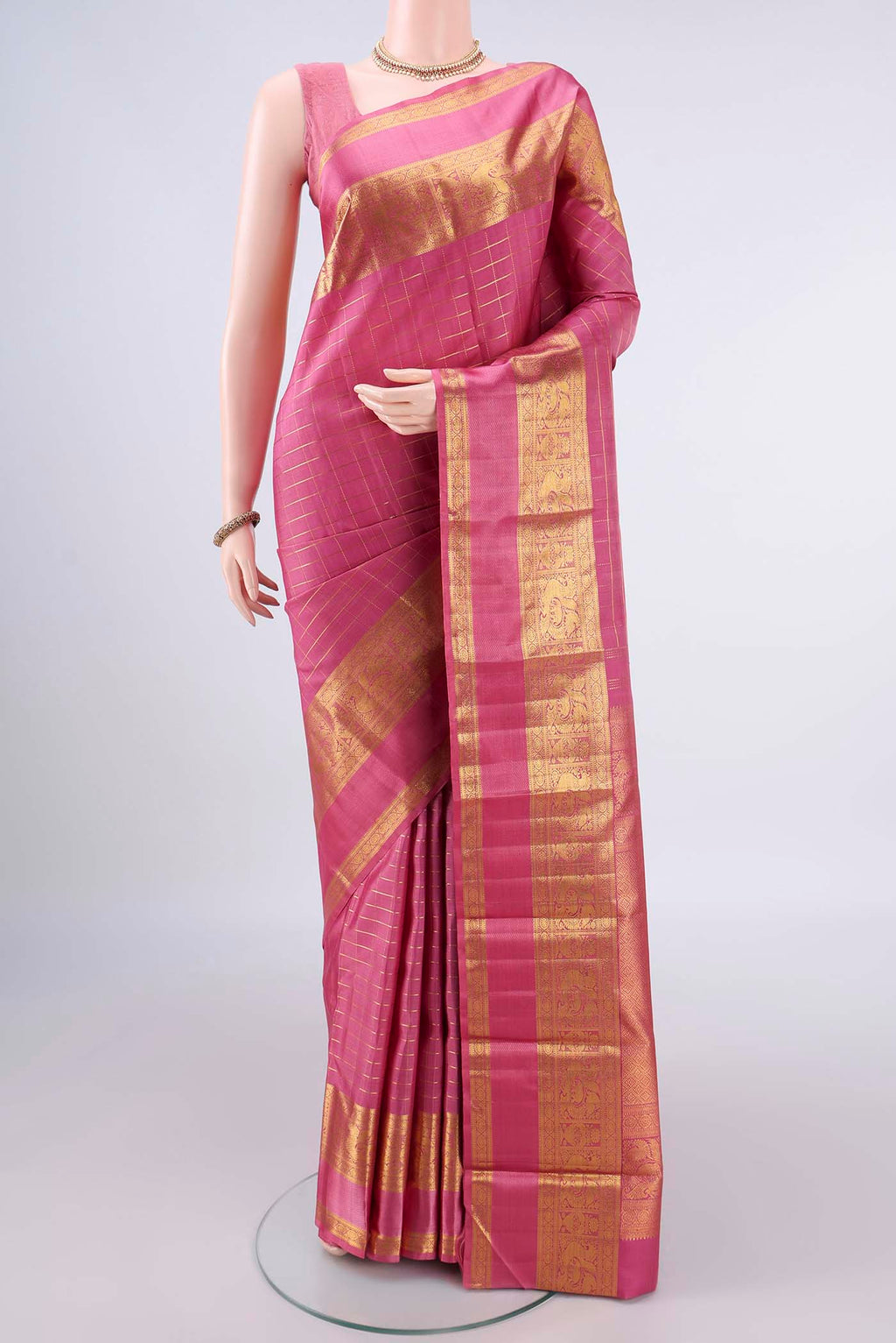 Pure Silk Pink Kanchipuram Saree with Checked design on the body and Zari Border.  displayed on a mannequin