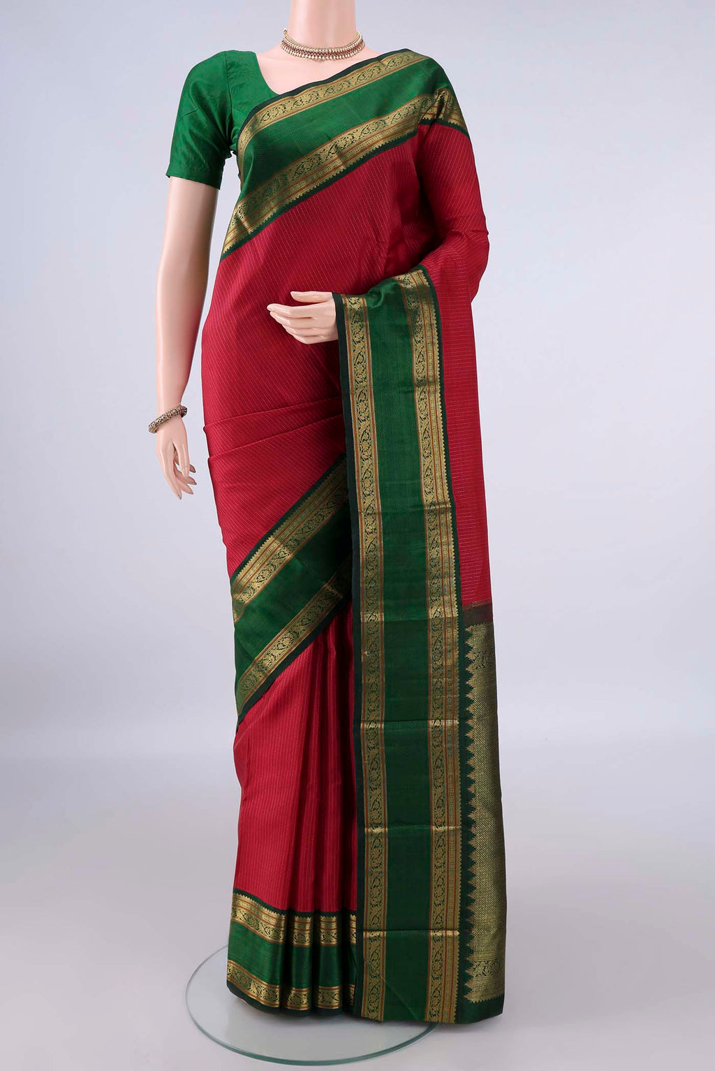 Pure Silk Deep Red Kanchipuram Saree with Stripes on the body and Zari Border.  displayed on a mannequin