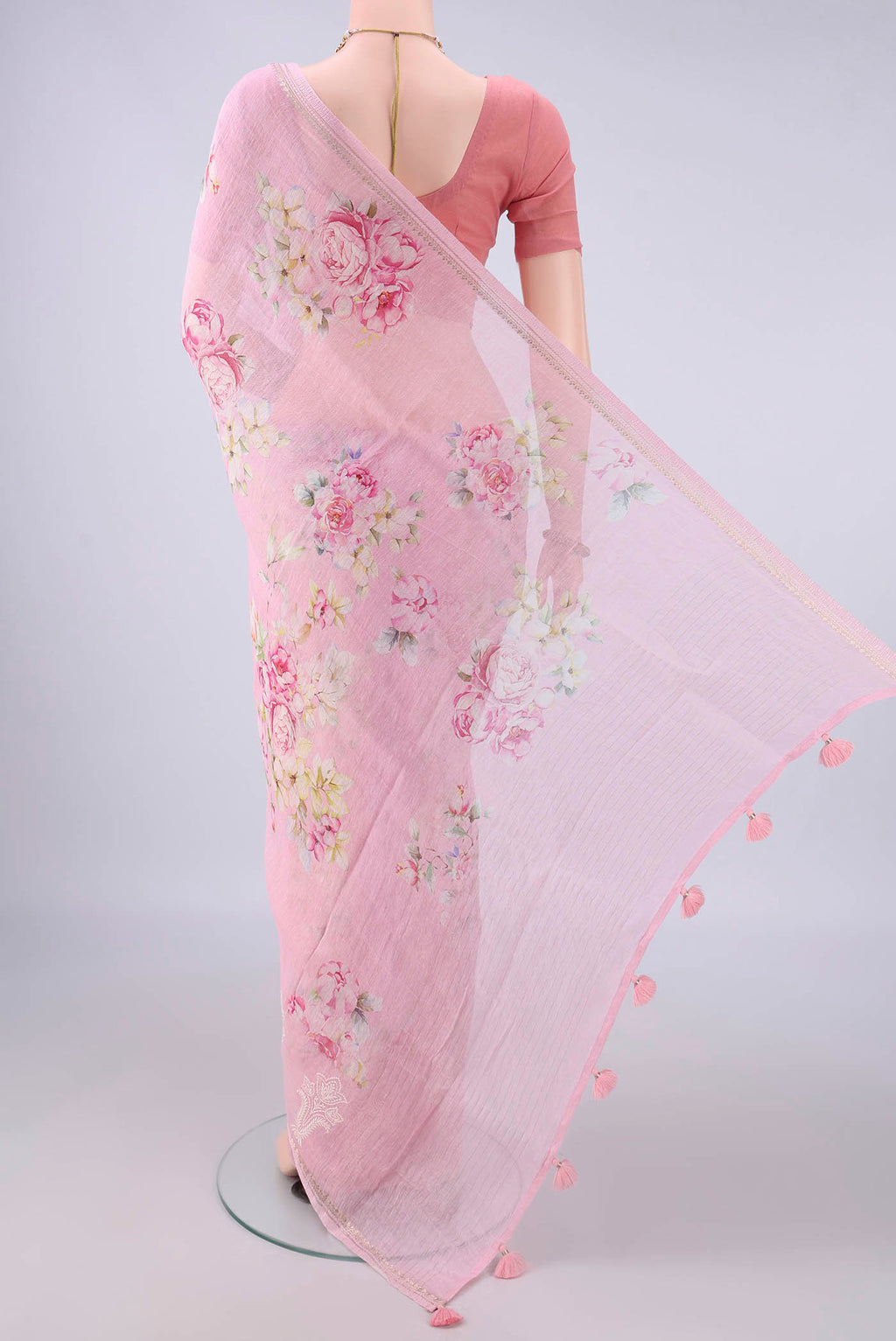 Flat view of Rose pink Linen Saree with Floral Print on the body and Zari Border. 