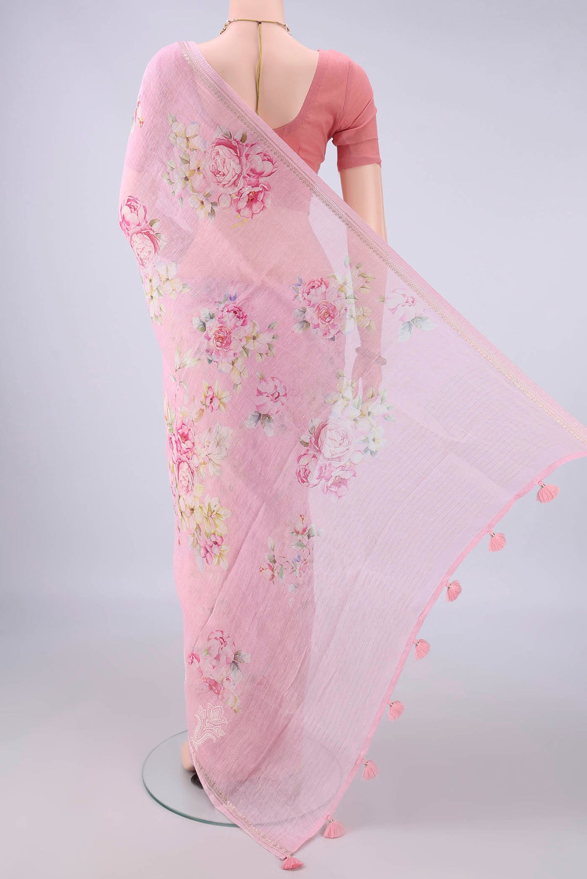 Flat view of Rose pink Linen Saree with Floral Print on the body and Zari Border. 
