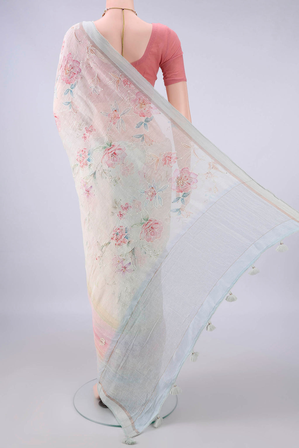 Flat view of Cream Linen Saree with Embroidery on the body and Thread Border. 