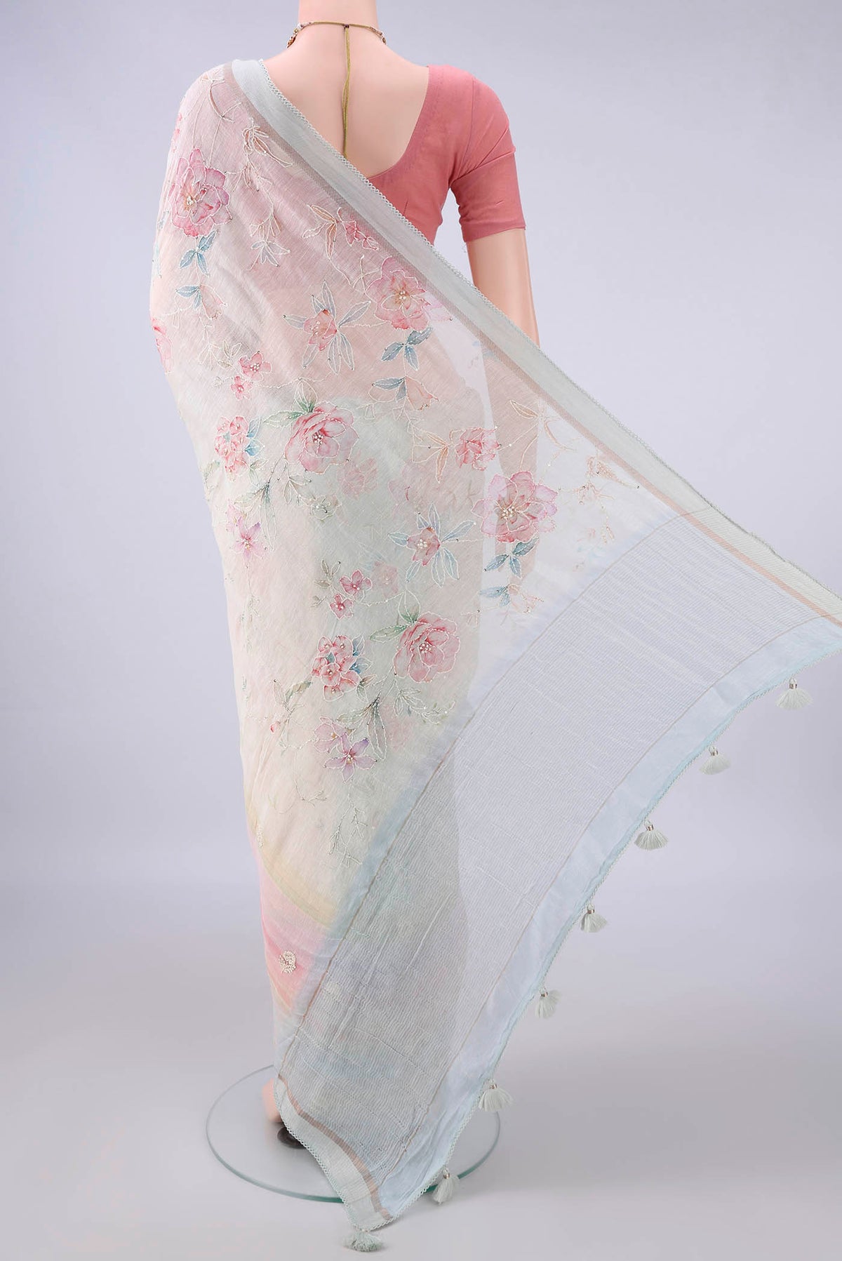 Flat view of Cream Linen Saree with Embroidery on the body and Thread Border. 