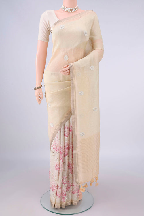 Beige Linen Saree with Floral Print on the body and Zari Border.  displayed on a mannequin