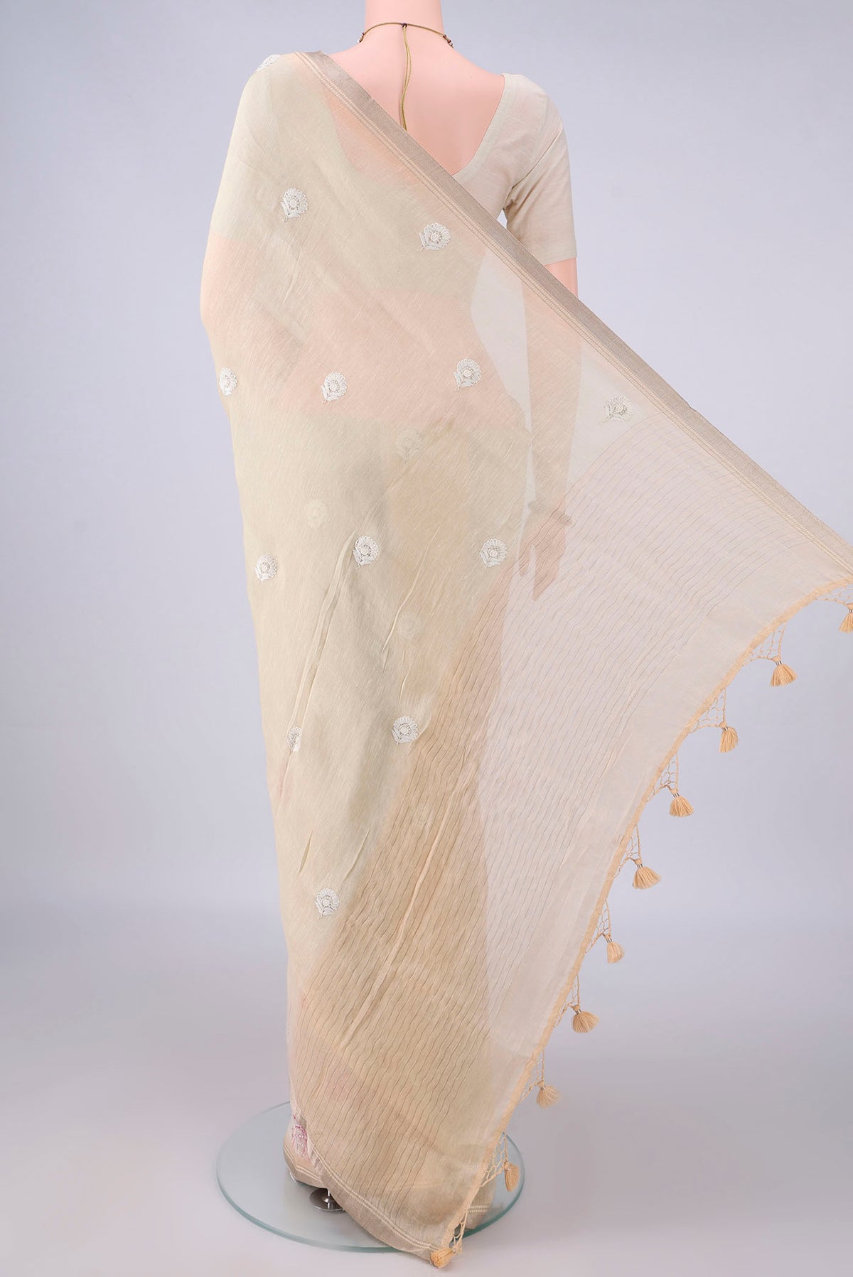 Flat view of Beige Linen Saree with Floral Print on the body and Zari Border. 