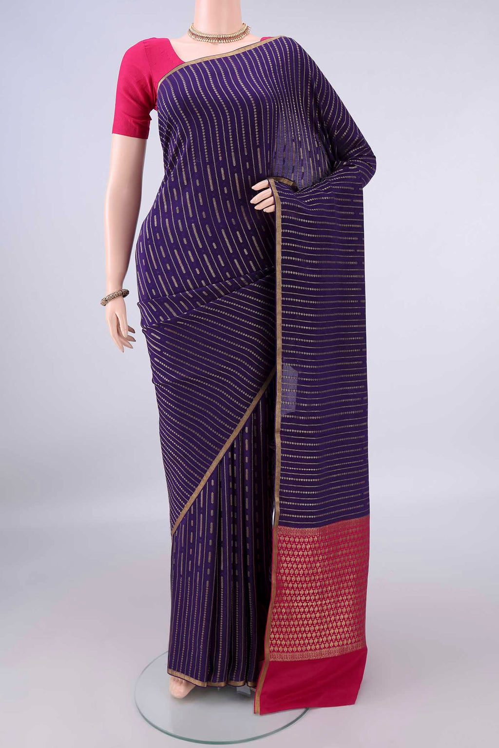 Navy Blue Mysore Crepe Saree with Stripes on the body and Zari Border.  displayed on a mannequin