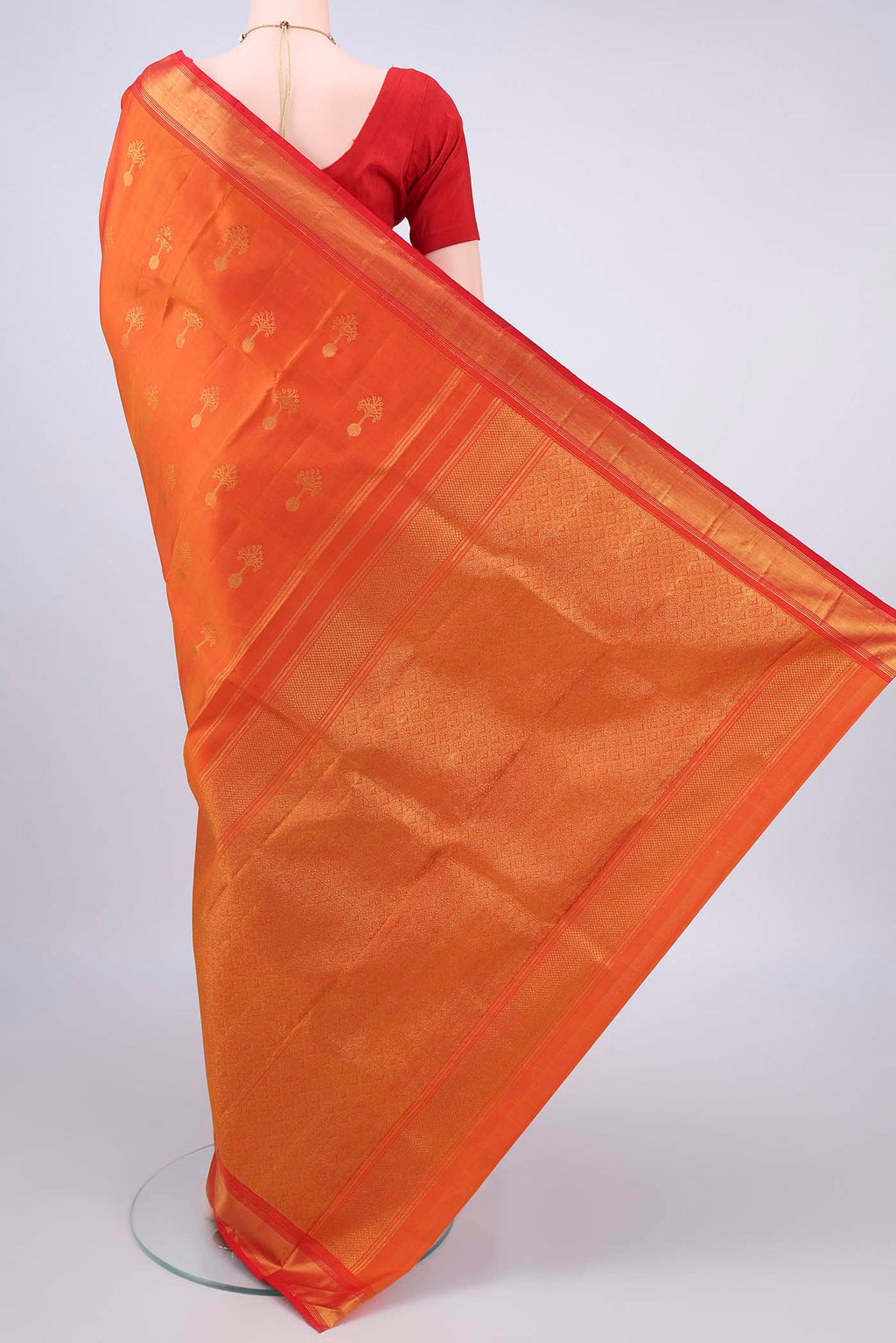 Flat view of Pure Silk Orange Kanjivaram Saree with Zari Butta on the body and Zari Border. 