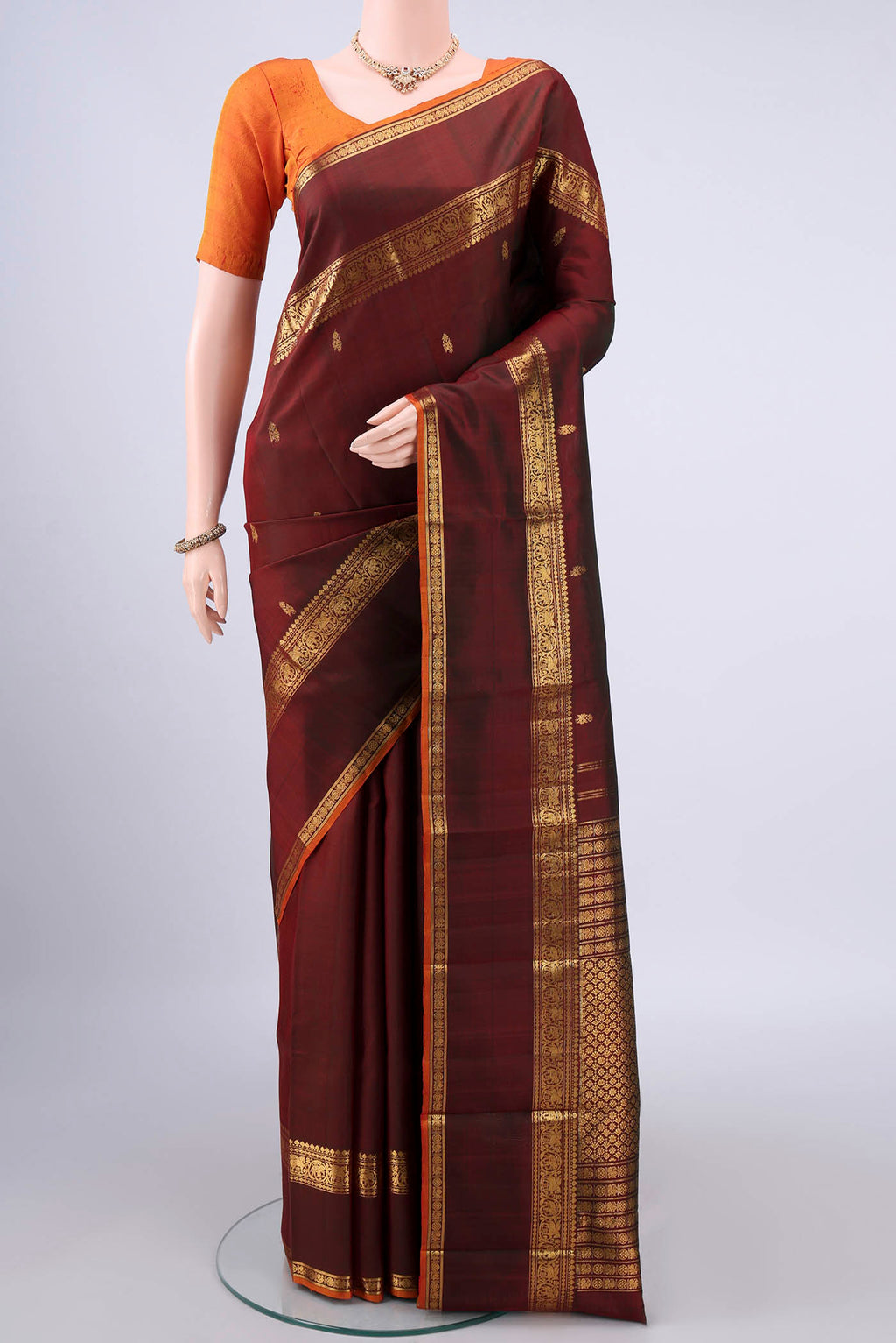 Pure Silk Brown Dual Tone Kanjivaram Saree with Zari Butta on the body and Zari Border.  displayed on a mannequin