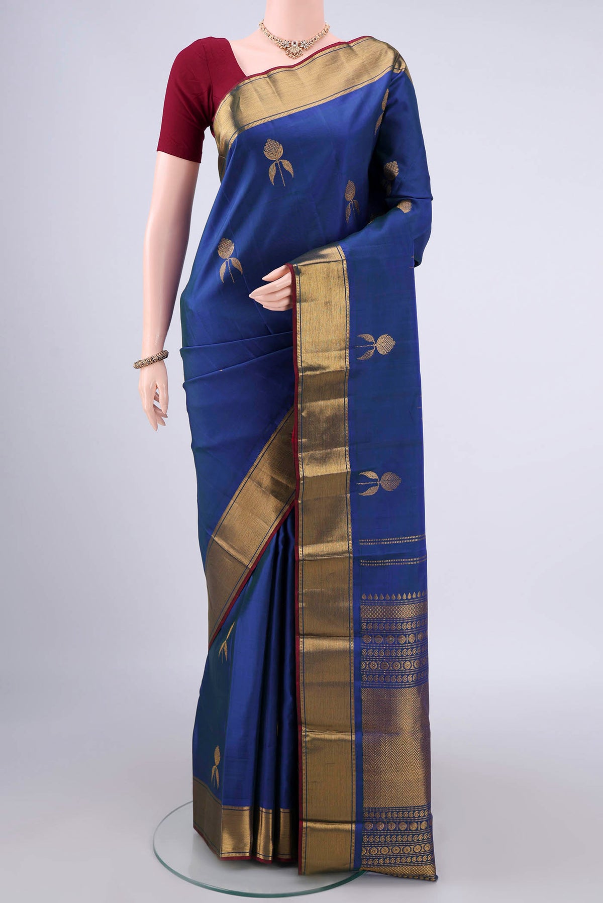 Pure Silk Royal Blue Kanjivaram Saree with Zari Butta on the body and Zari Border.  displayed on a mannequin