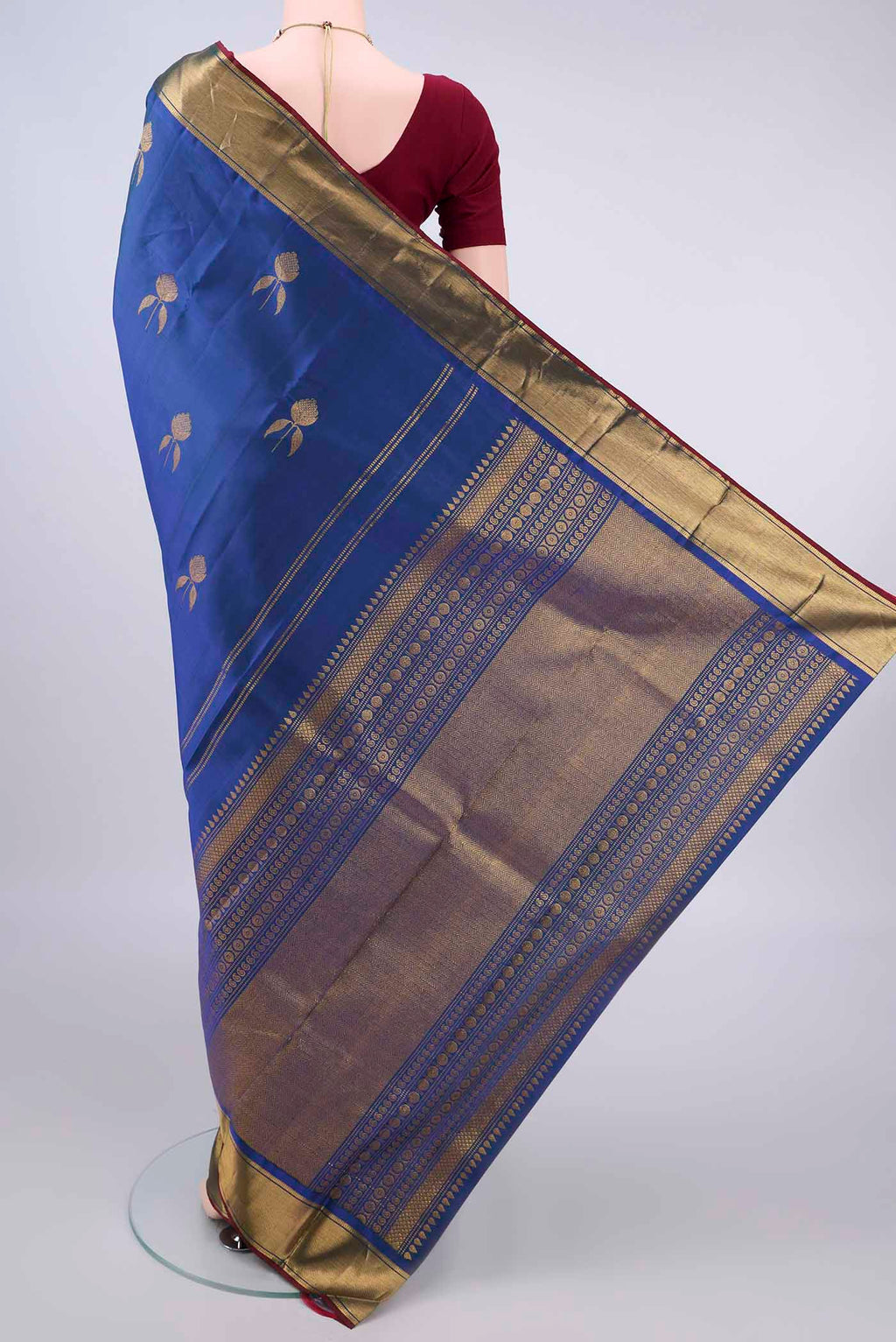 Flat view of Pure Silk Royal Blue Kanjivaram Saree with Zari Butta on the body and Zari Border. 