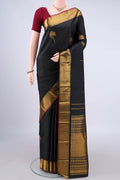 Pure Silk Black Kanjivaram Saree with Zari Butta on the body and Zari Border.  displayed on a mannequin