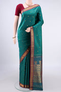 Pure Silk Sea Green Kanjivaram Saree with Zari Butta on the body and Zari Border.  displayed on a mannequin