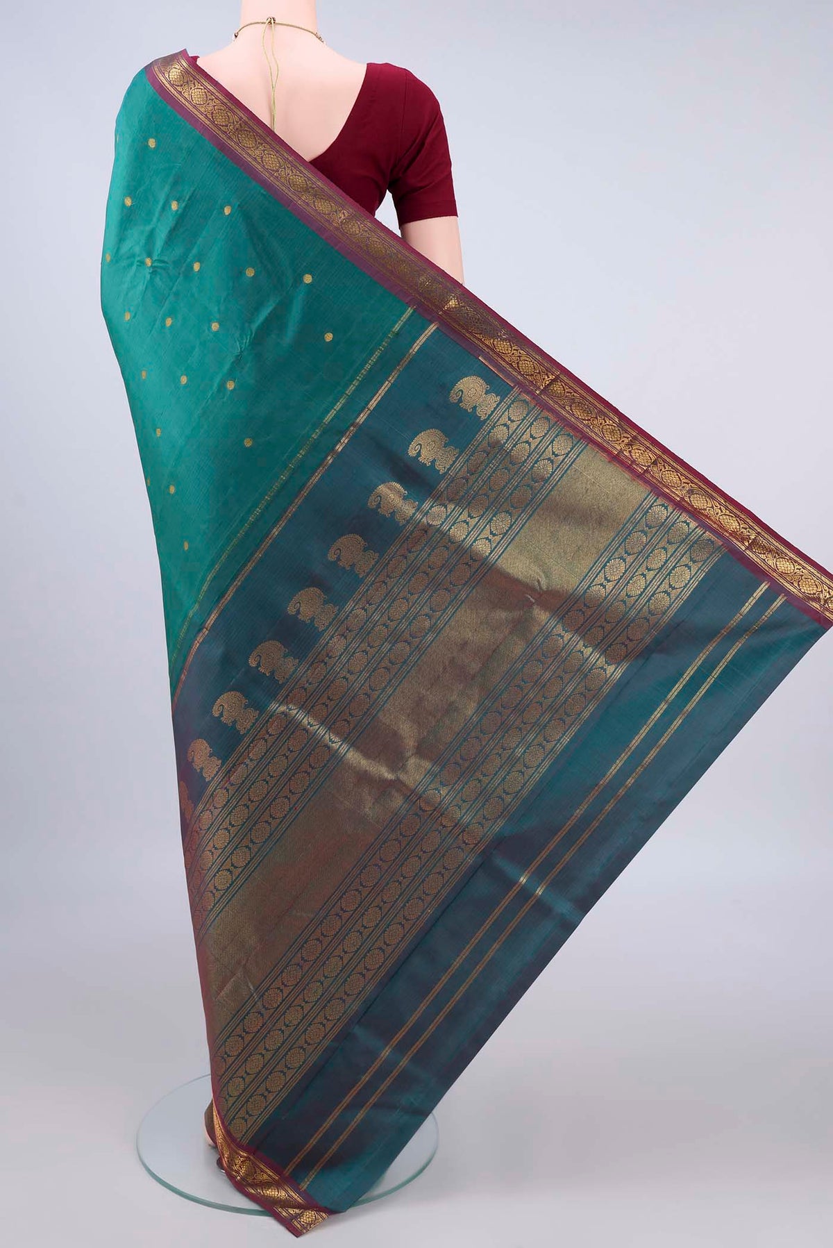 Flat view of Pure Silk Sea Green Kanjivaram Saree with Zari Butta on the body and Zari Border. 