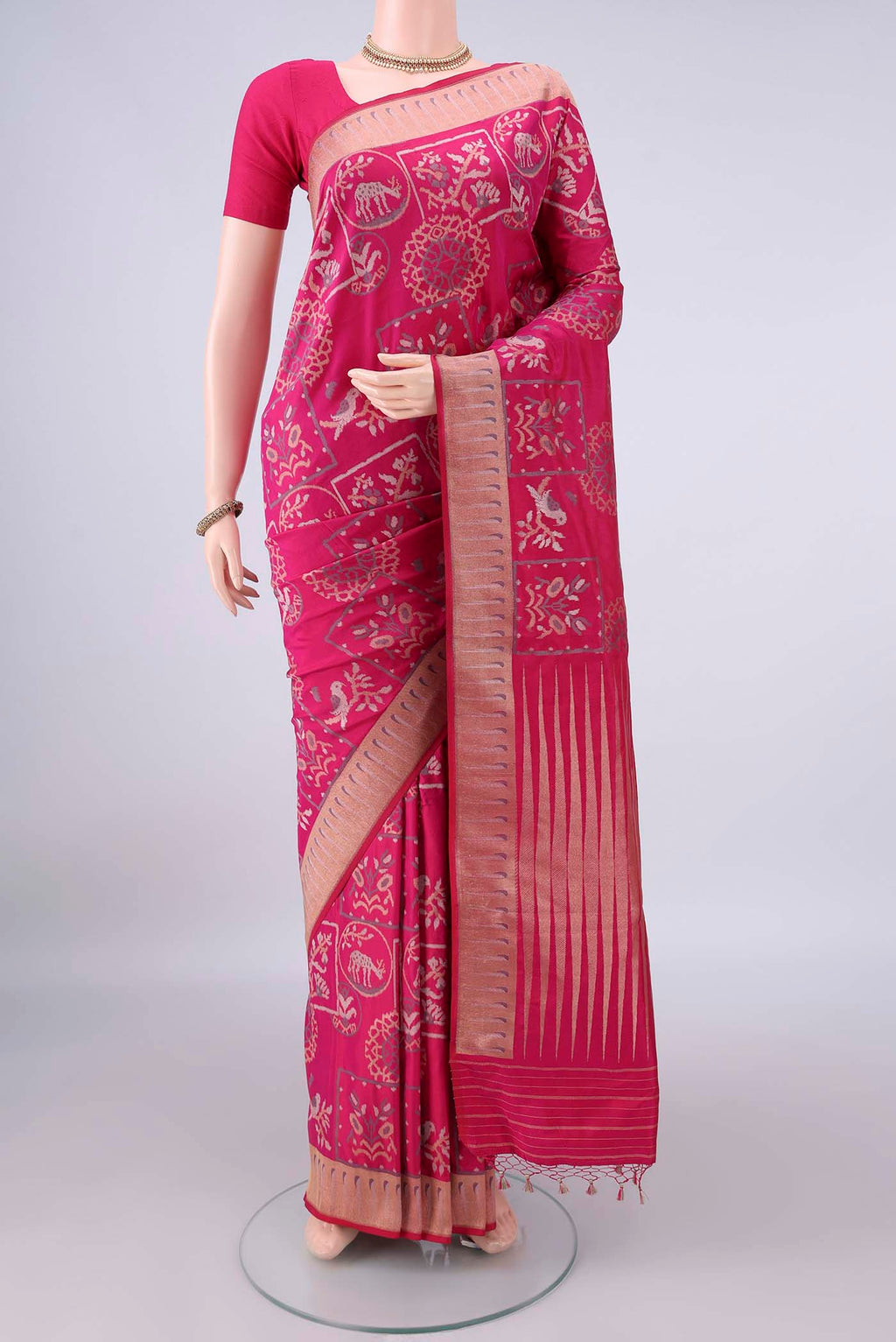 Pure Silk Rani Pink Banarasi Saree with Zari Butta on the body and Zari Border.  displayed on a mannequin