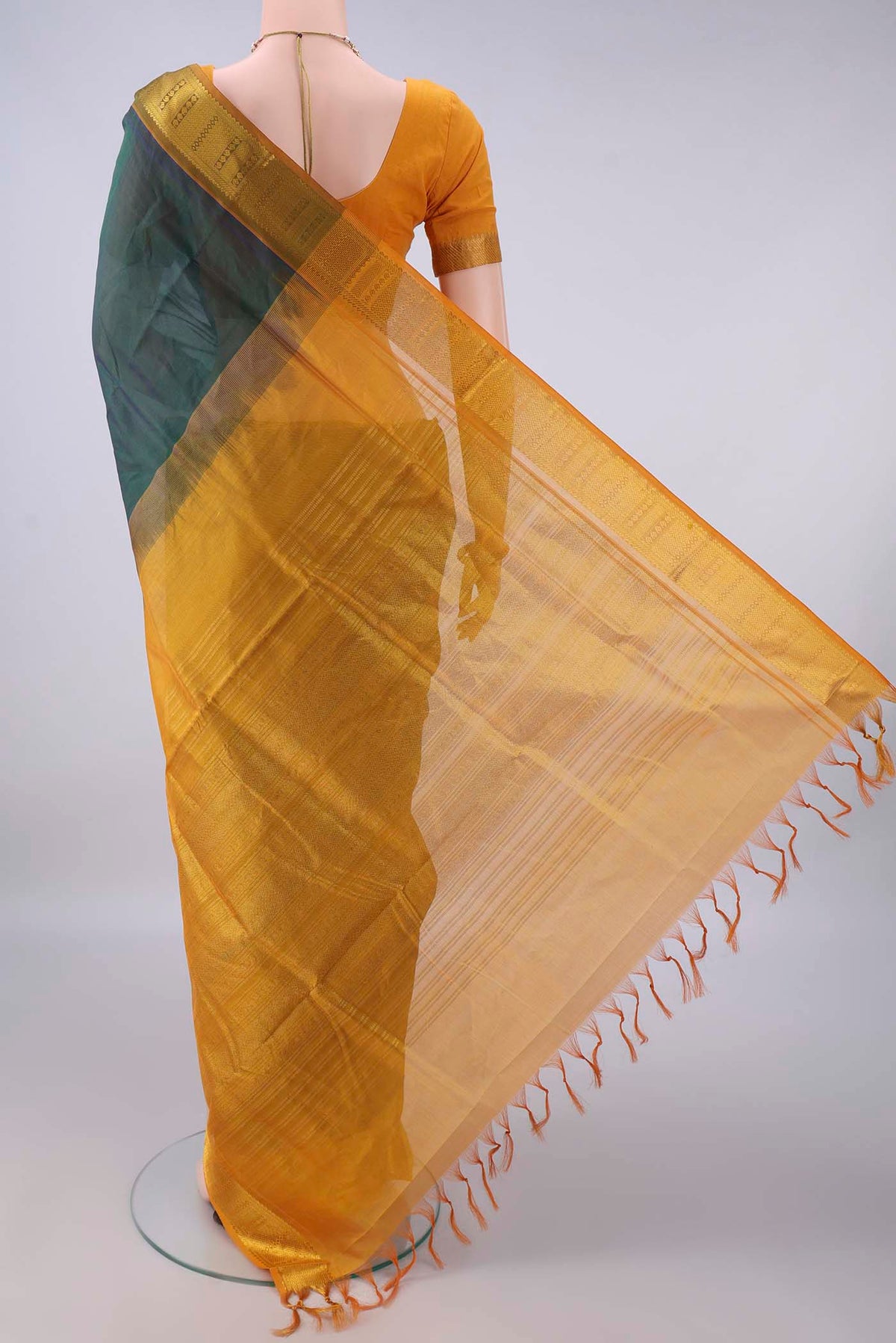 Flat view of Bottle Green Silk Cotton Saree with Plain Body and Zari Border. 