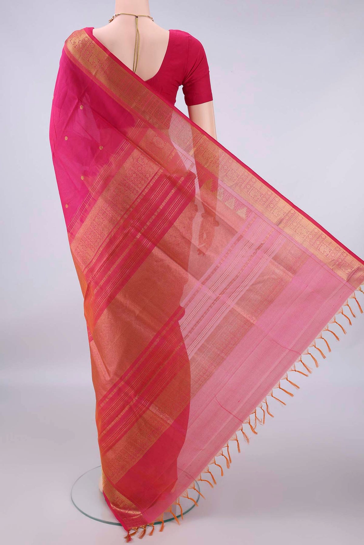 Flat view of Rani Pink Silk Cotton Saree with Zari Butta on the body and Zari Border. 