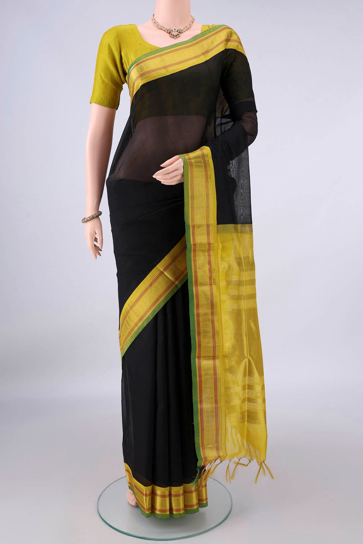 Black Silk Cotton Saree with Plain Body and Zari Border.  displayed on a mannequin