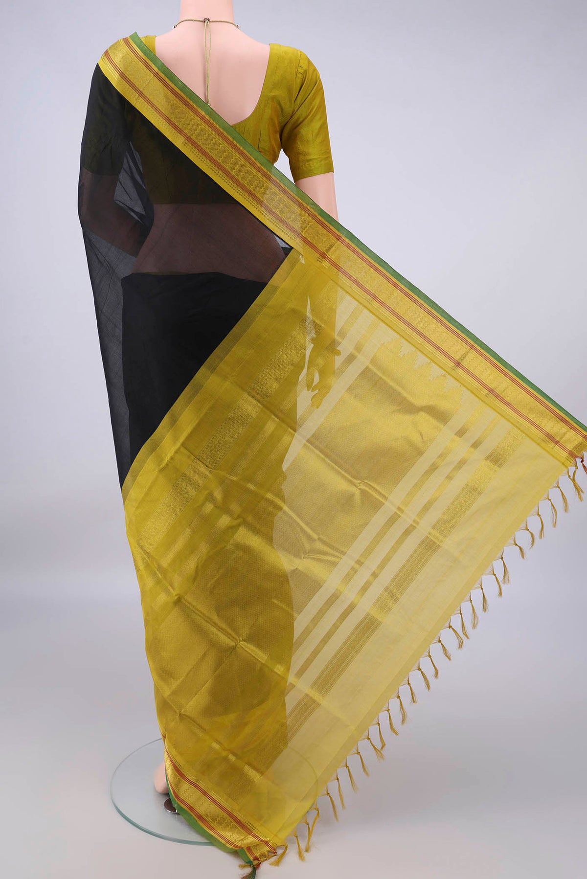 Flat view of Black Silk Cotton Saree with Plain Body and Zari Border. 
