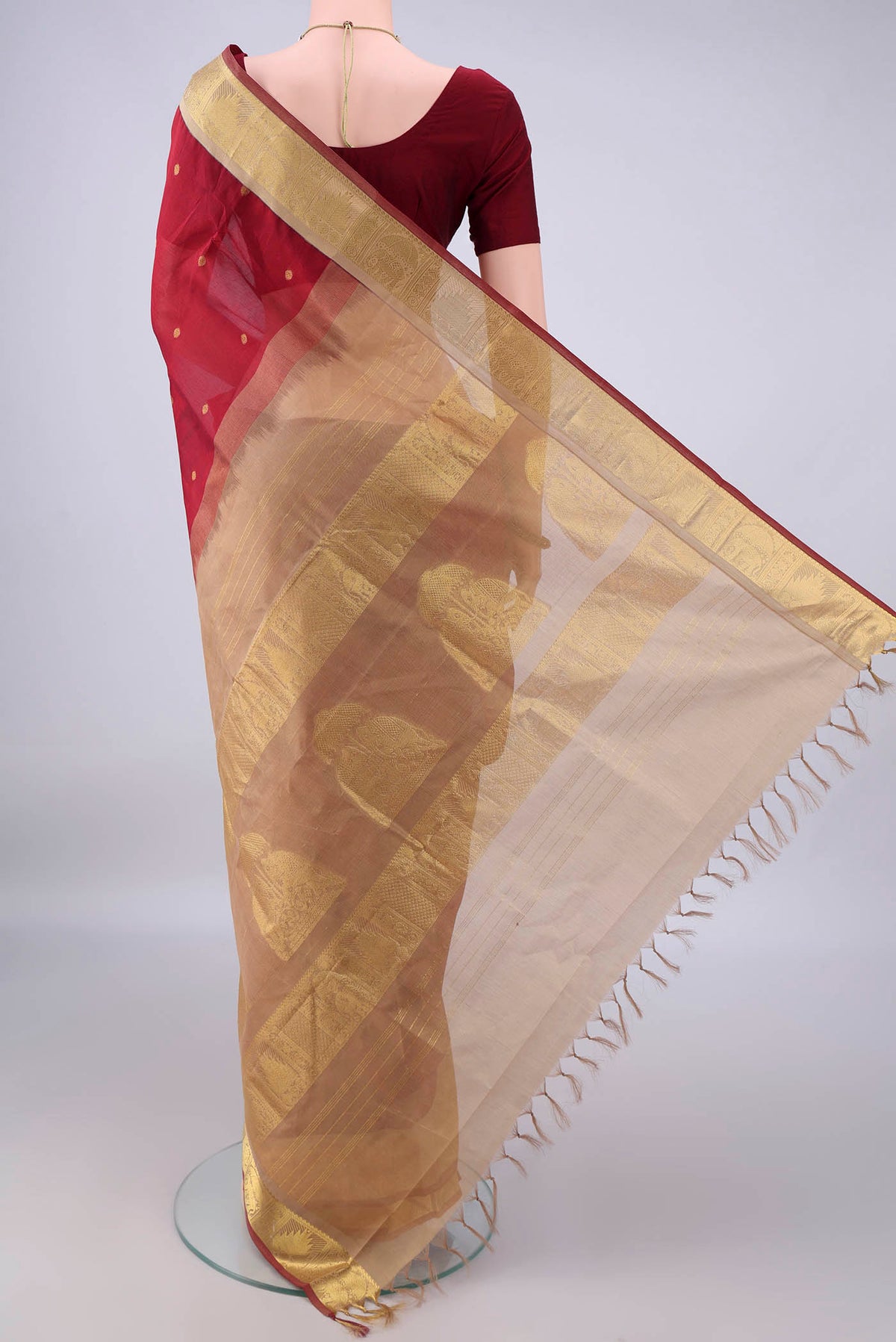 Flat view of Maroon Silk Cotton Saree with Zari Butta on the body and Zari Border. 