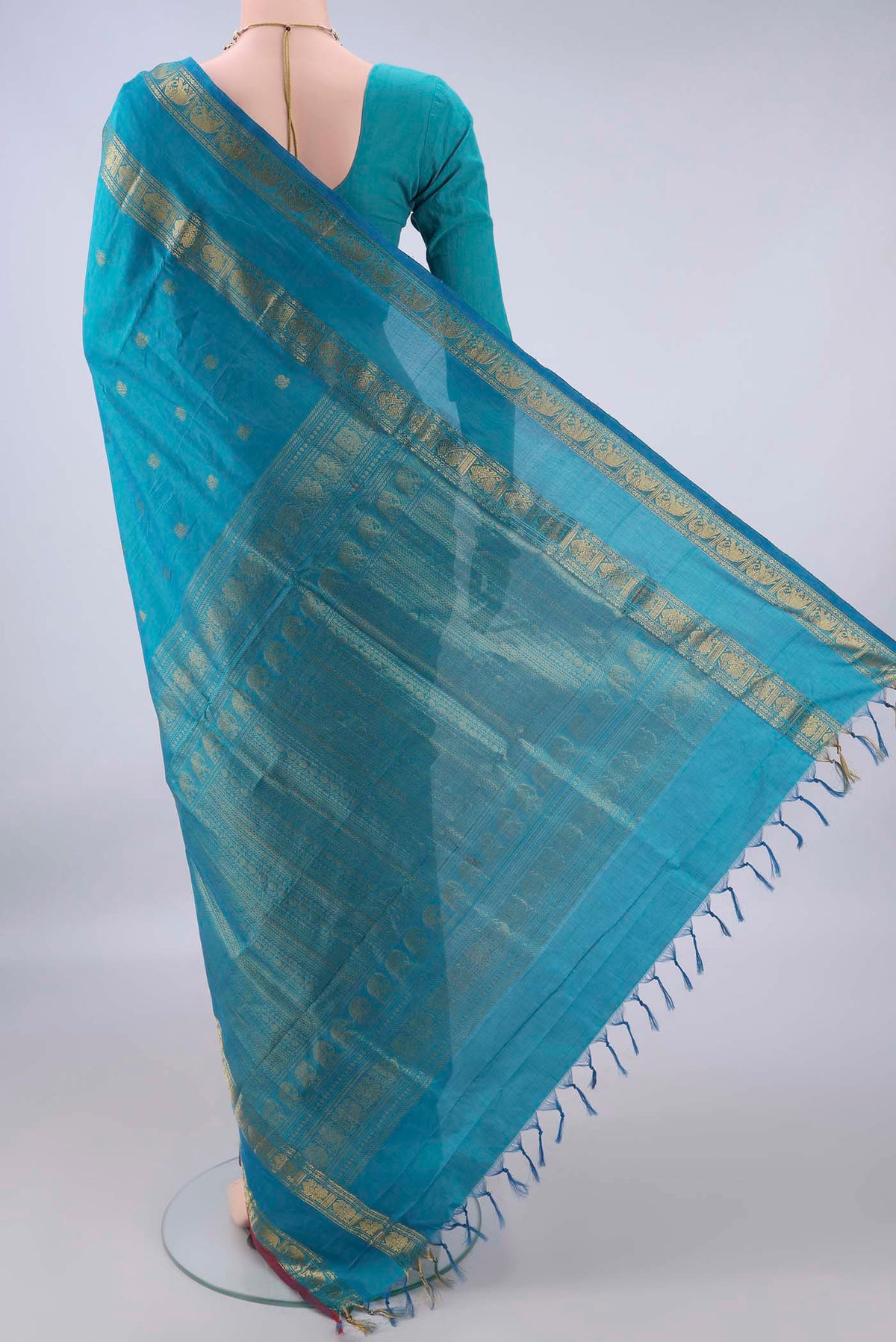 Flat view of Sea Green Silk Cotton Saree with Zari Butta on the body and Zari Border. 