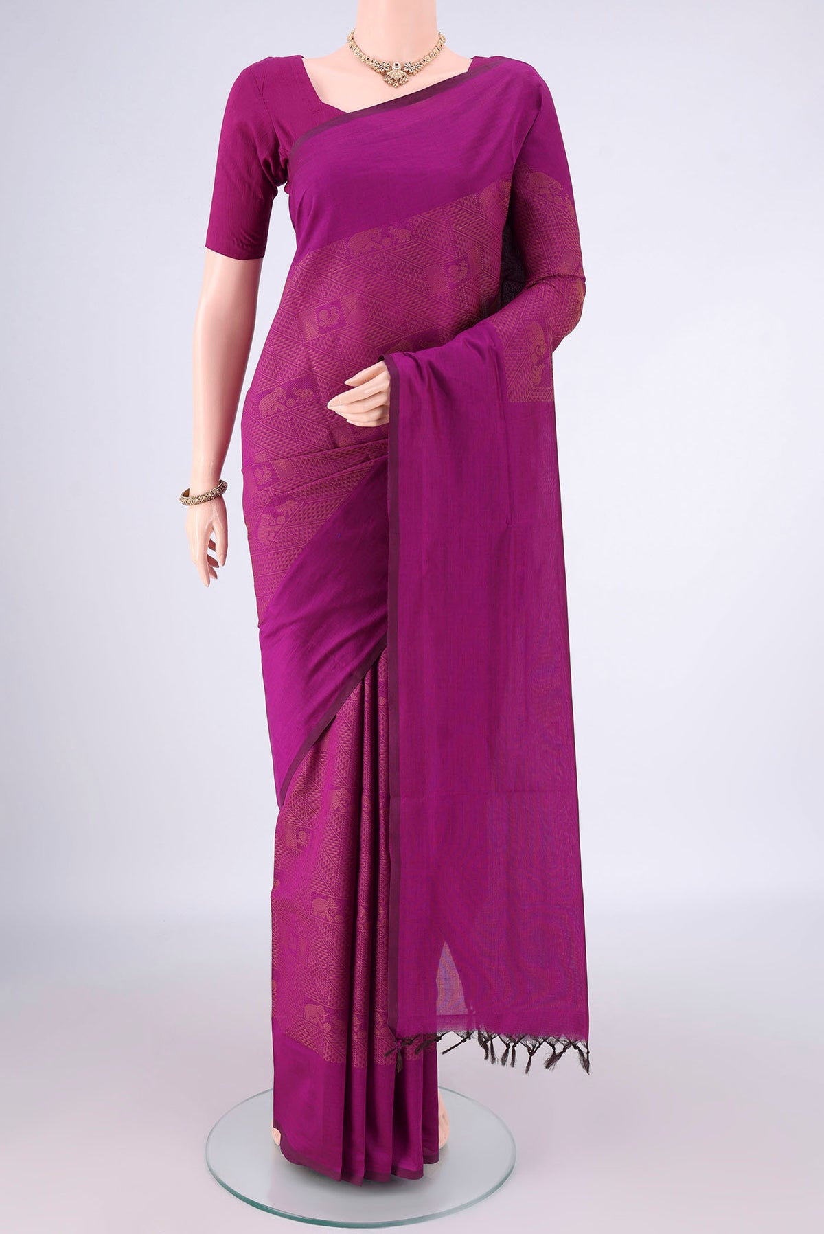 Magenta Blended Poly Cotton Saree with Jacquard design on the body and Thread Border.  displayed on a mannequin