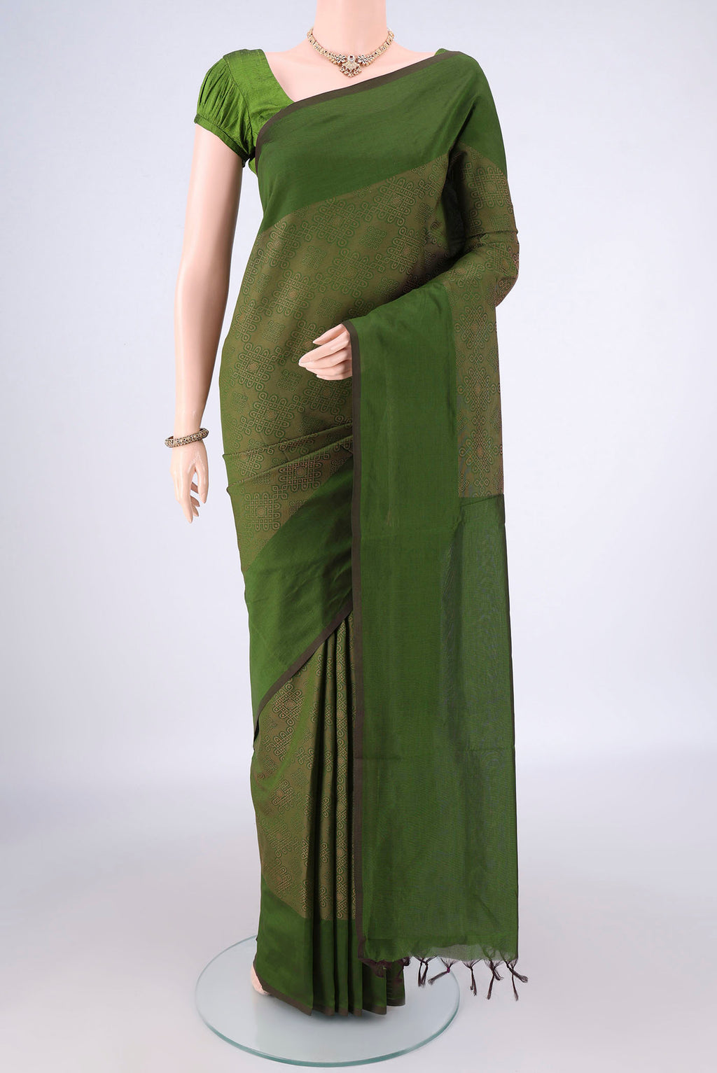 Mehandi Green Blended Poly Cotton Saree with Jacquard design on the body and Thread Border.  displayed on a mannequin
