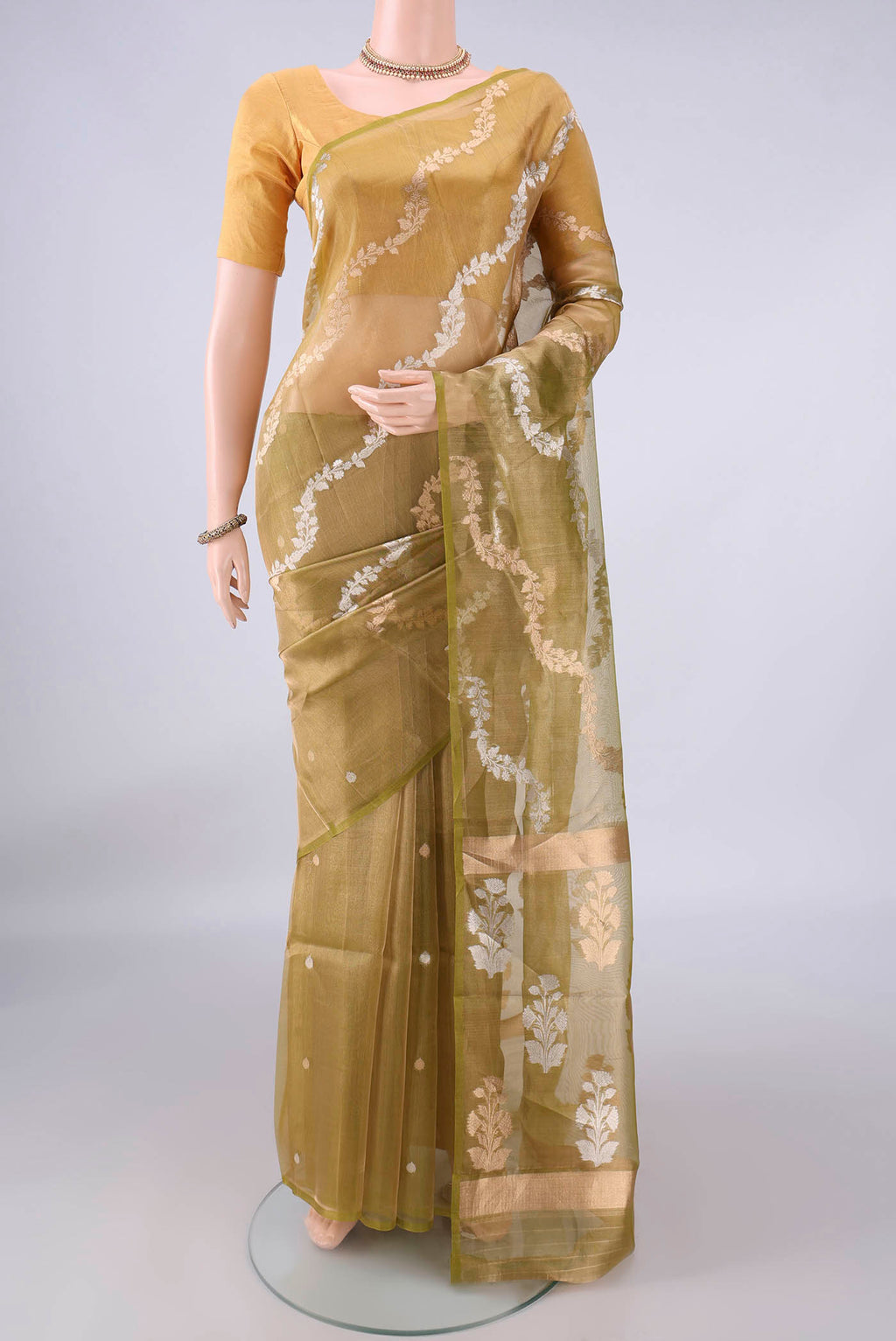 Light Green Dual Tone Organza Saree with Fancy on the body and Plain Border.  displayed on a mannequin