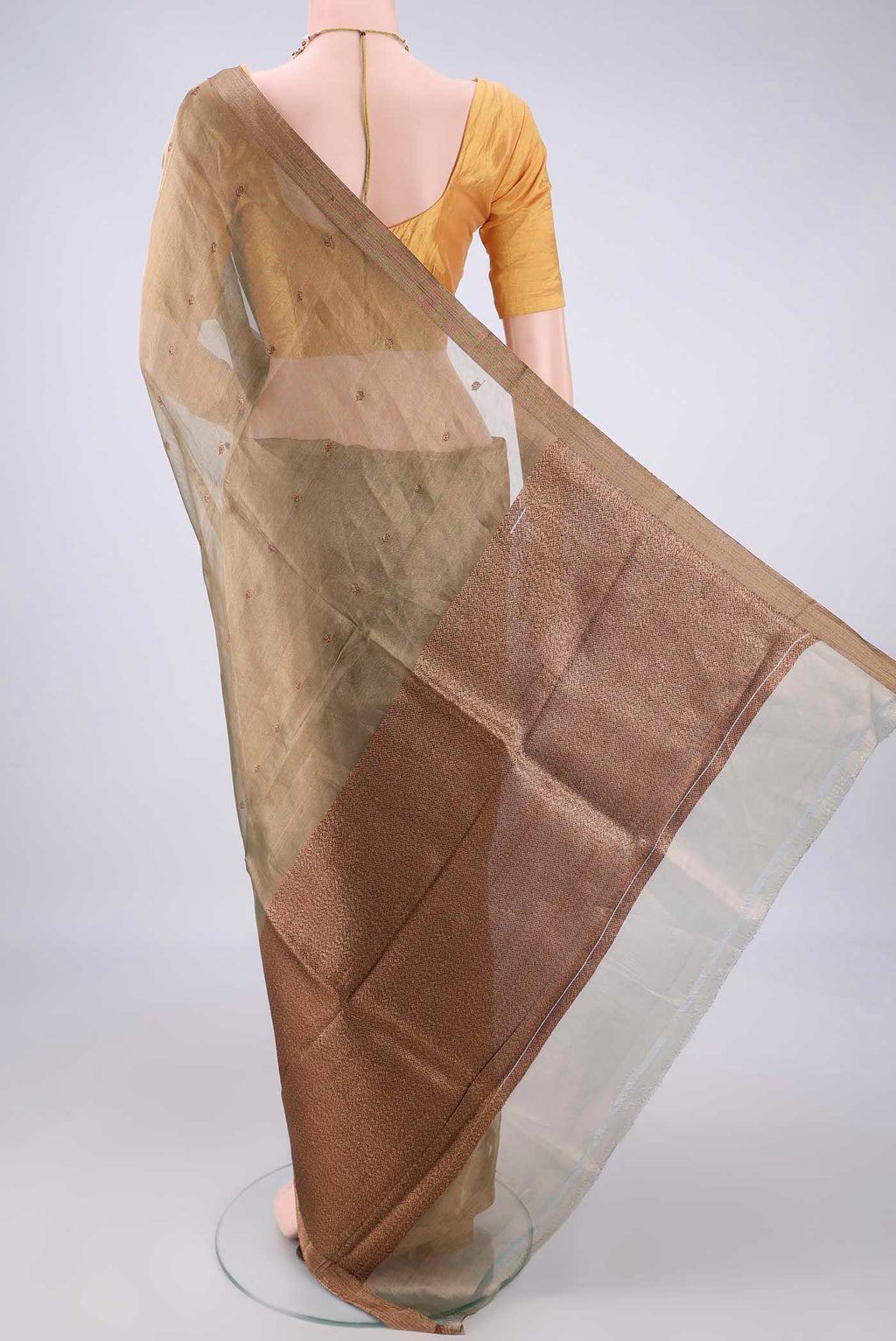 Flat view of Sage Green Organza Saree with Zari And Thread Butta on the body and Zari Border. 