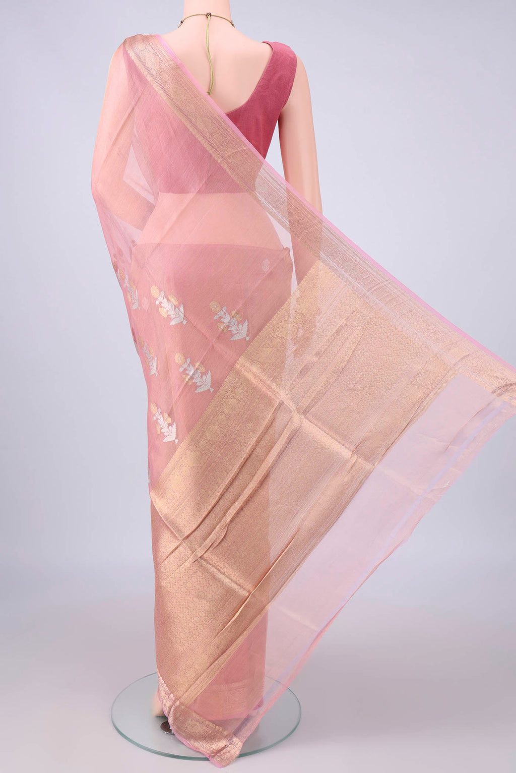 Flat view of Peach Organza Saree with Zari Butta on the body and Zari Border. 