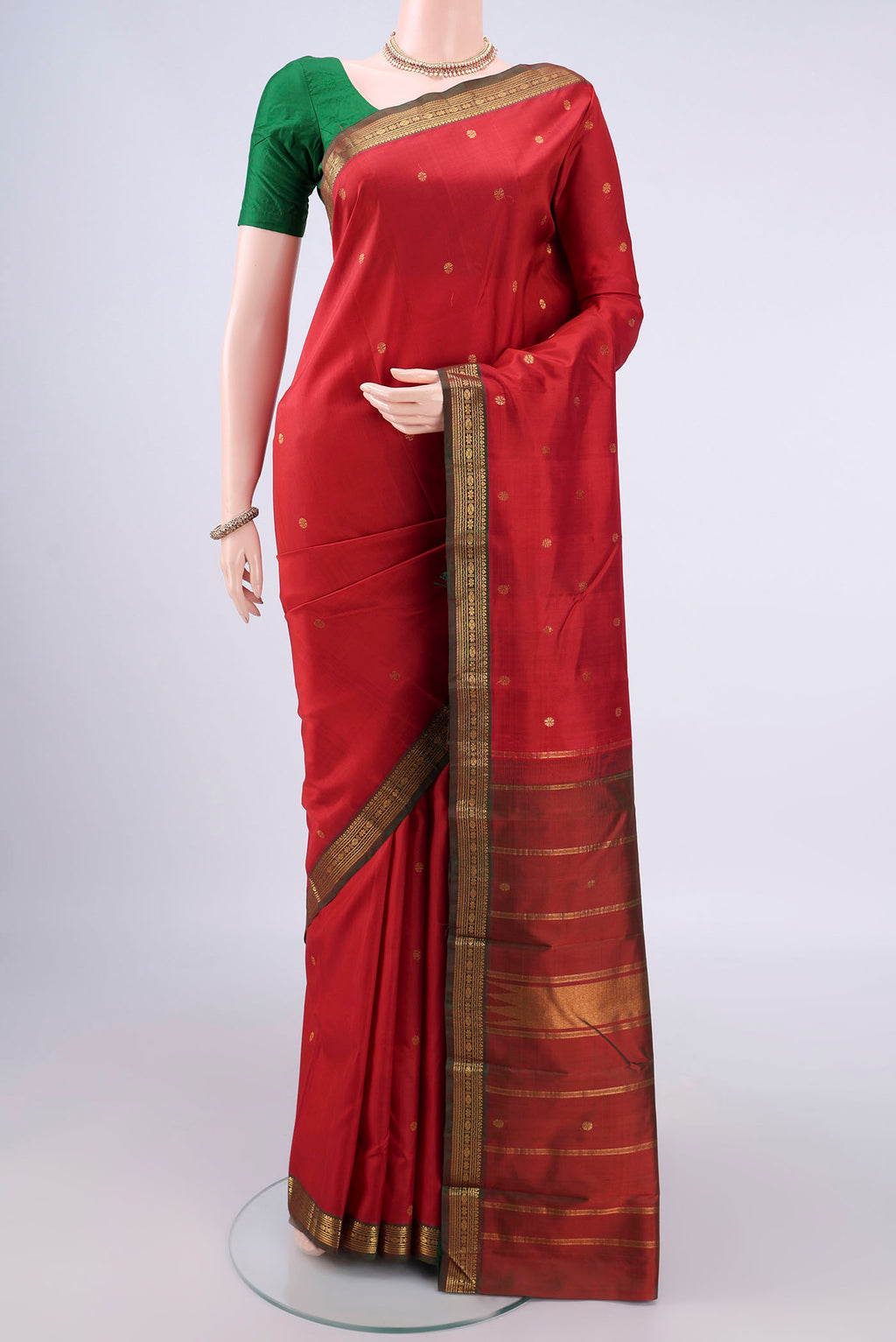 Pure Silk Red Kanchipuram Saree with Zari Butta on the body and Zari Border.  displayed on a mannequin