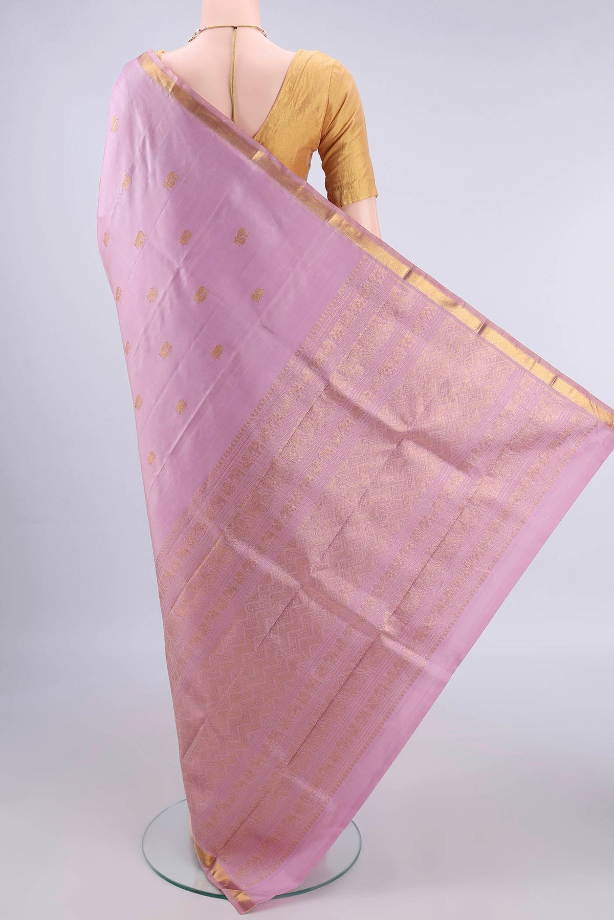 Flat view of Pure Silk Rose pink Kanjivaram Saree with Zari Butta on the body and Zari Border. 