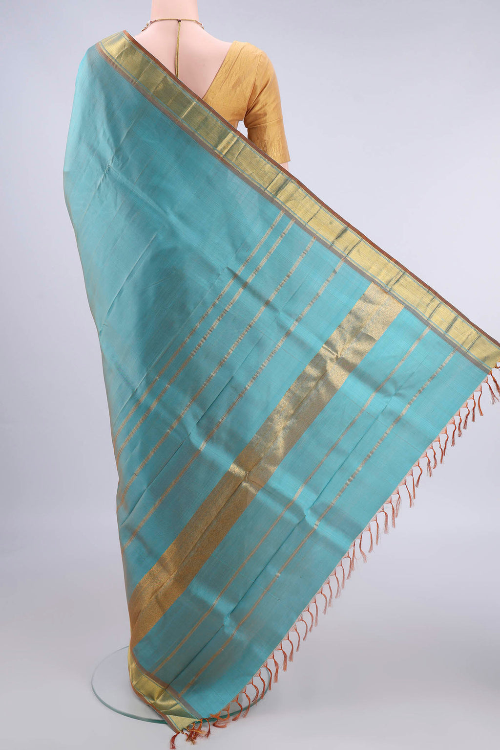 Flat view of Pure Silk Turquoise Kanjivaram Saree with Zari Butta on the body and Zari Border. 