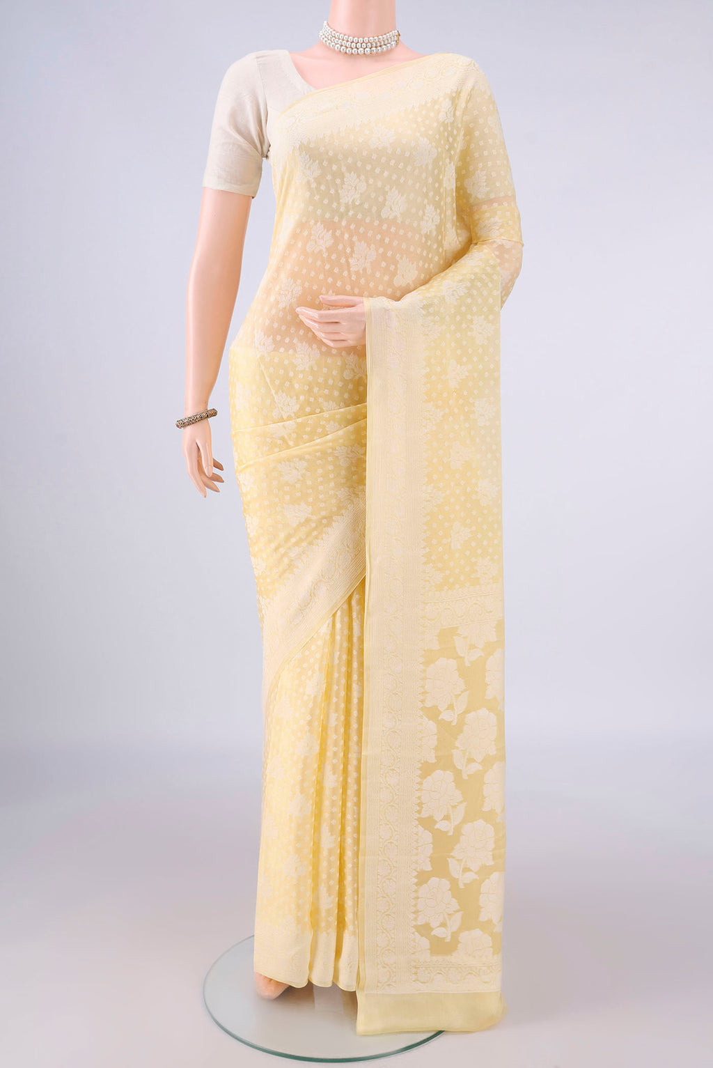 Yellow Blended Banarasi Georgette Saree with Thread Brocade on the body and Thread Border.  displayed on a mannequin