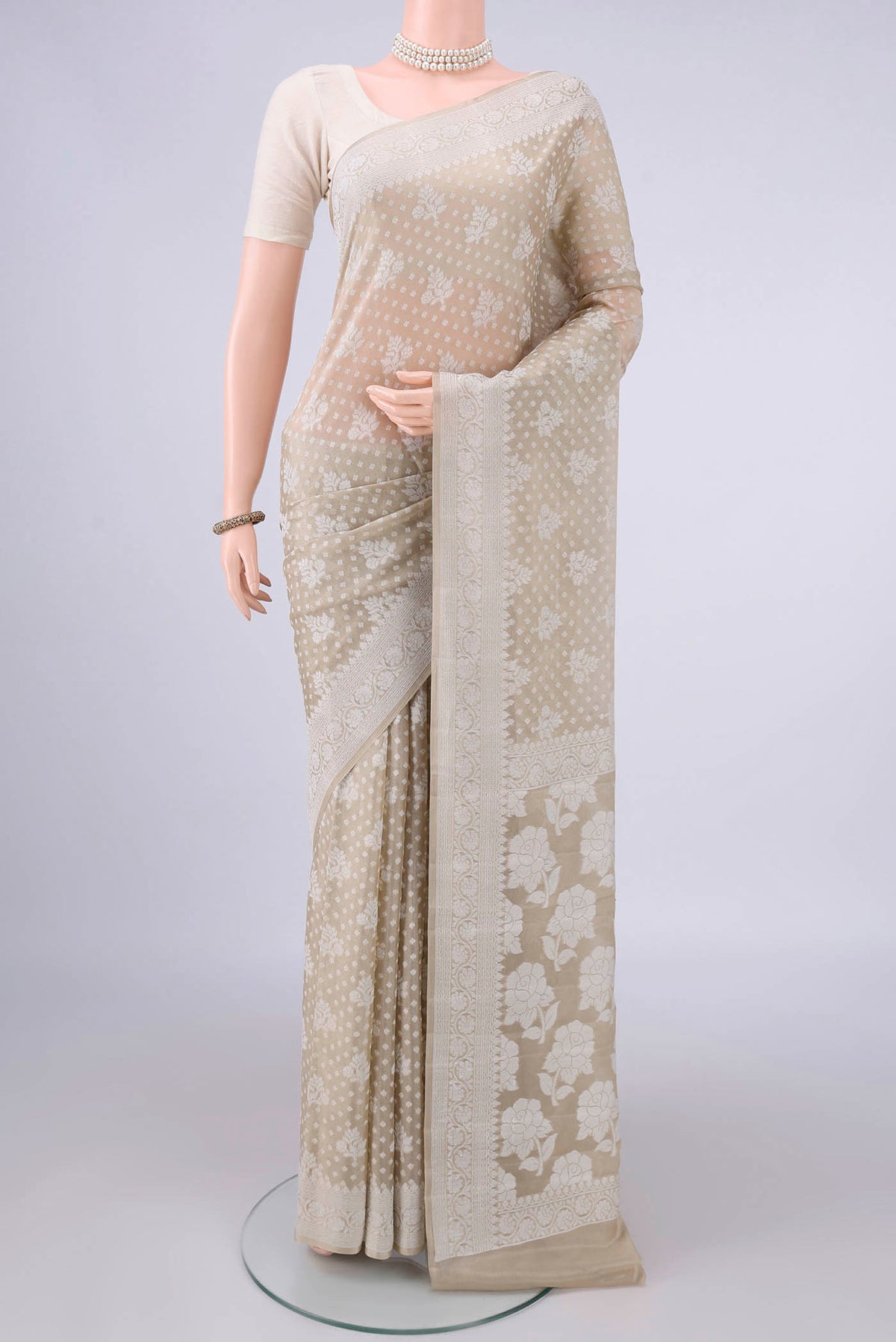 Beige Blended Banarasi Georgette Saree with Thread Brocade on the body and Thread Border.  displayed on a mannequin