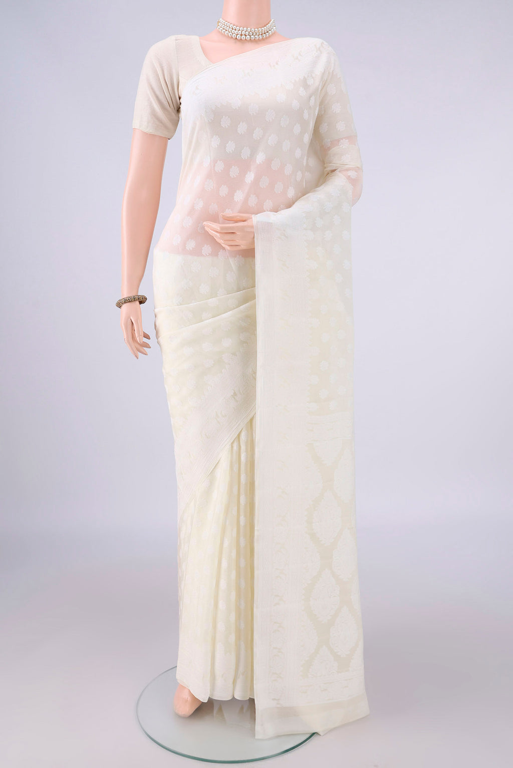 Off White Blended Banarasi Georgette Saree with Thread Butta on the body and Thread Border.  displayed on a mannequin