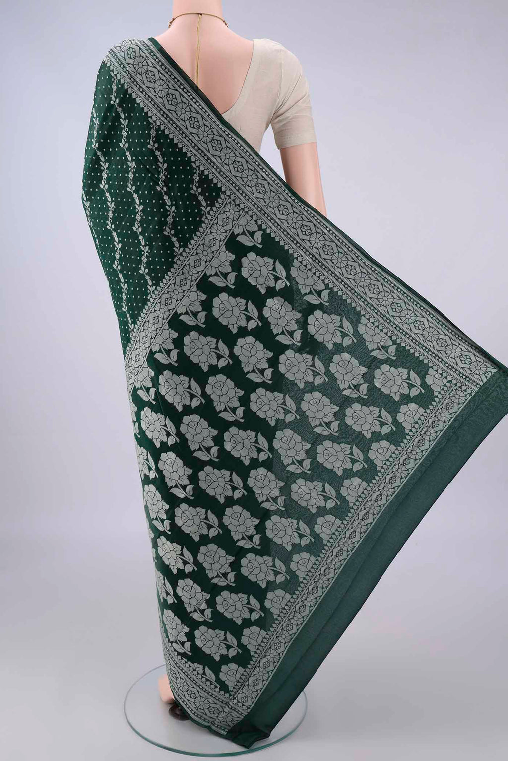 Flat view of Bottle Green Blended Banarasi Georgette Saree with Thread Butta on the body and Thread Border. 