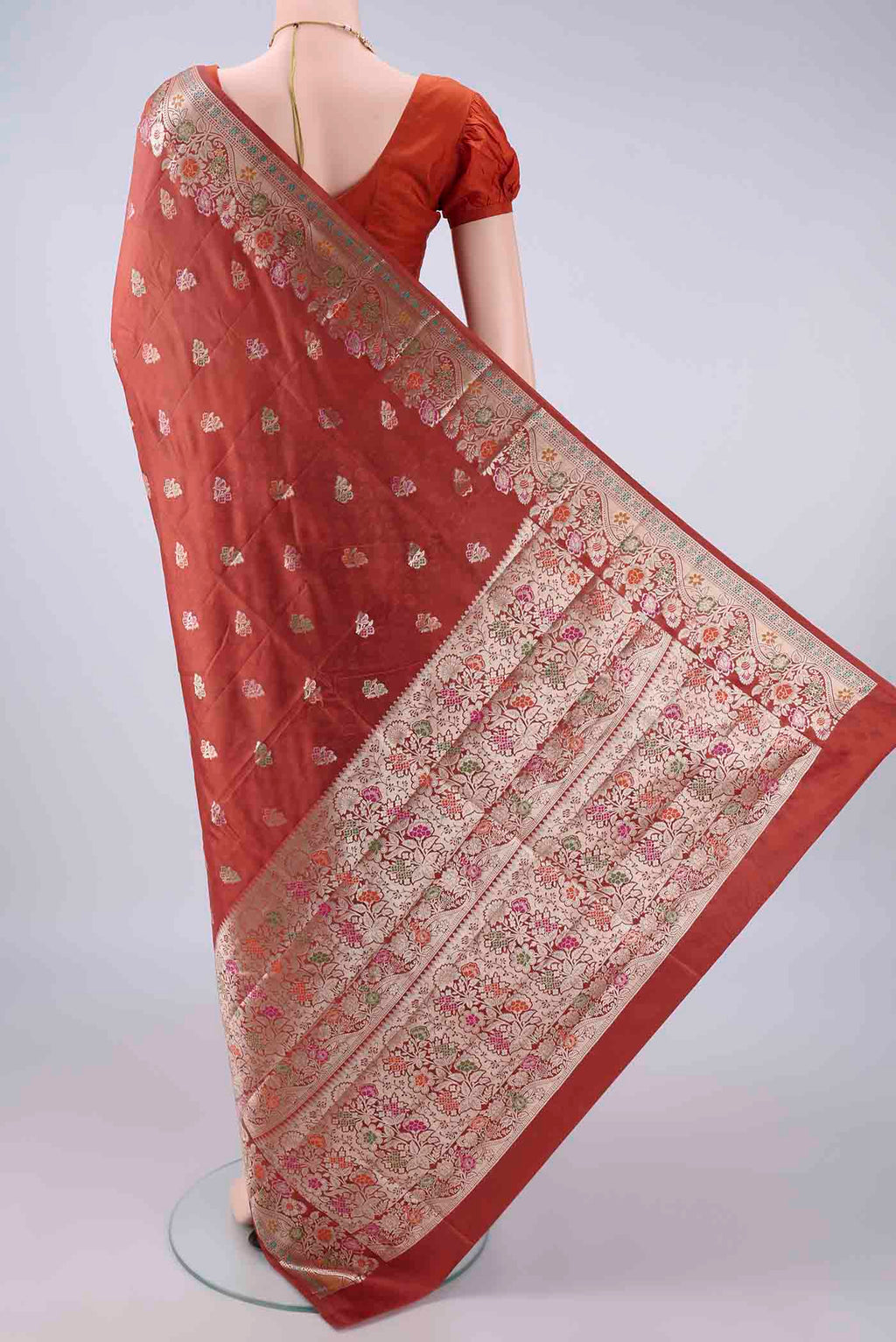 Flat view of Pure Silk Rust Banarasi Raw Saree with Zari Butta on the body and Zari And Thread Border. 