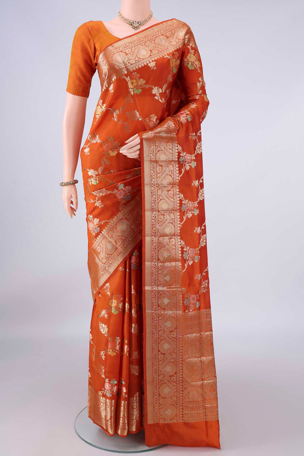 Pure Silk Orange Banarasi Raw Saree with Zari Brocade on the body and Zari Border.  displayed on a mannequin