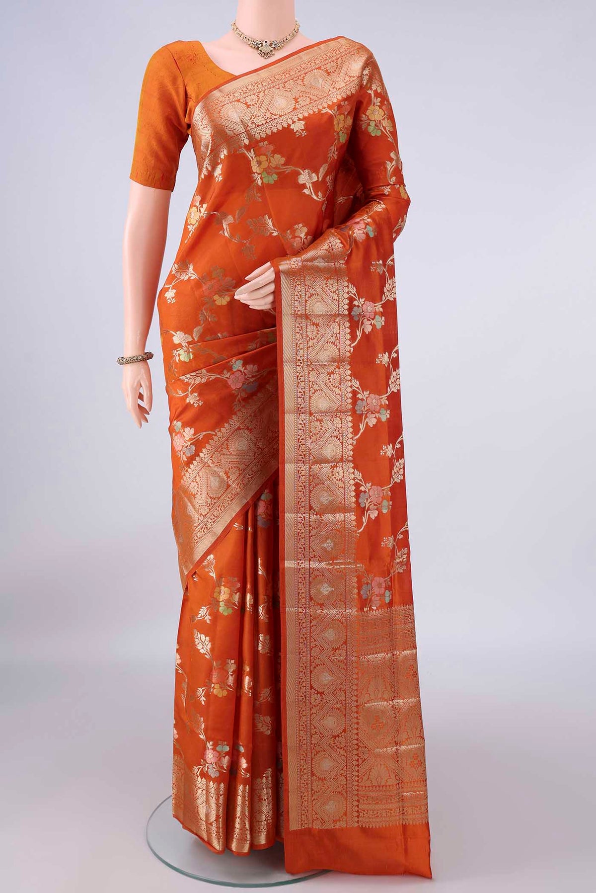 Pure Silk Orange Banarasi Raw Saree with Zari Brocade on the body and Zari Border.  displayed on a mannequin