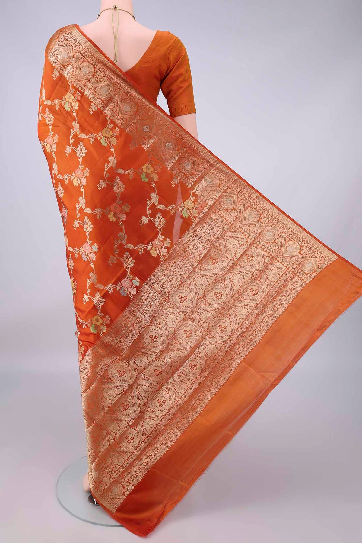 Flat view of Pure Silk Orange Banarasi Raw Saree with Zari Brocade on the body and Zari Border. 