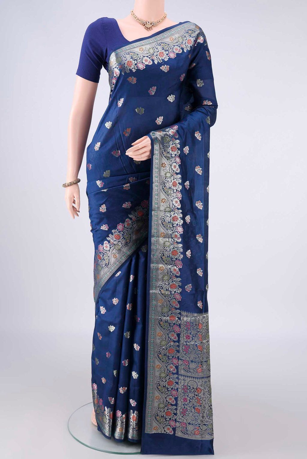 Pure Silk Blue Banarasi Raw Saree with Zari Butta on the body and Zari And Thread Border.  displayed on a mannequin