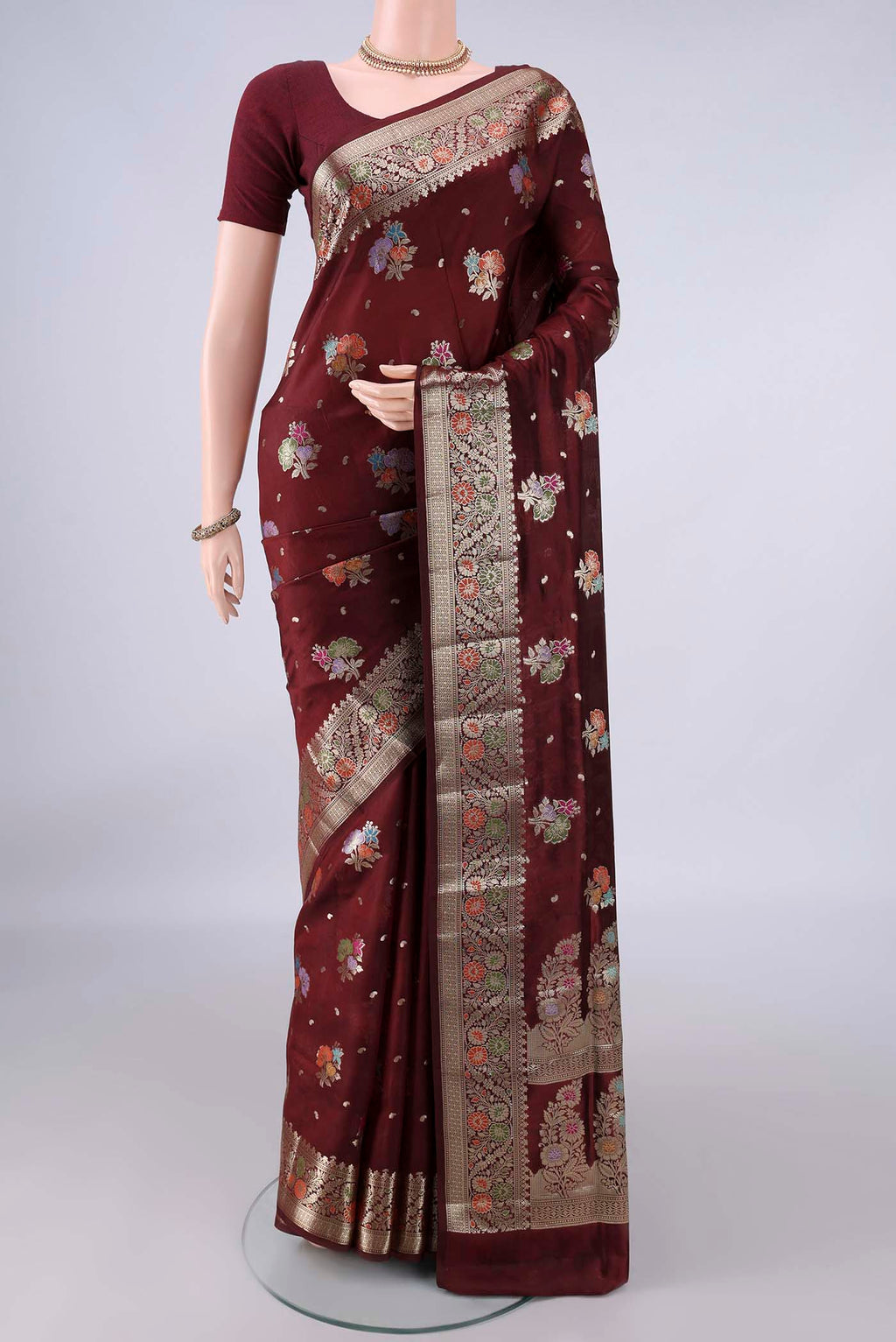 Pure Silk Coffee Brown Banarasi Raw Saree with Zari Butta on the body and Zari And Thread Border.  displayed on a mannequin