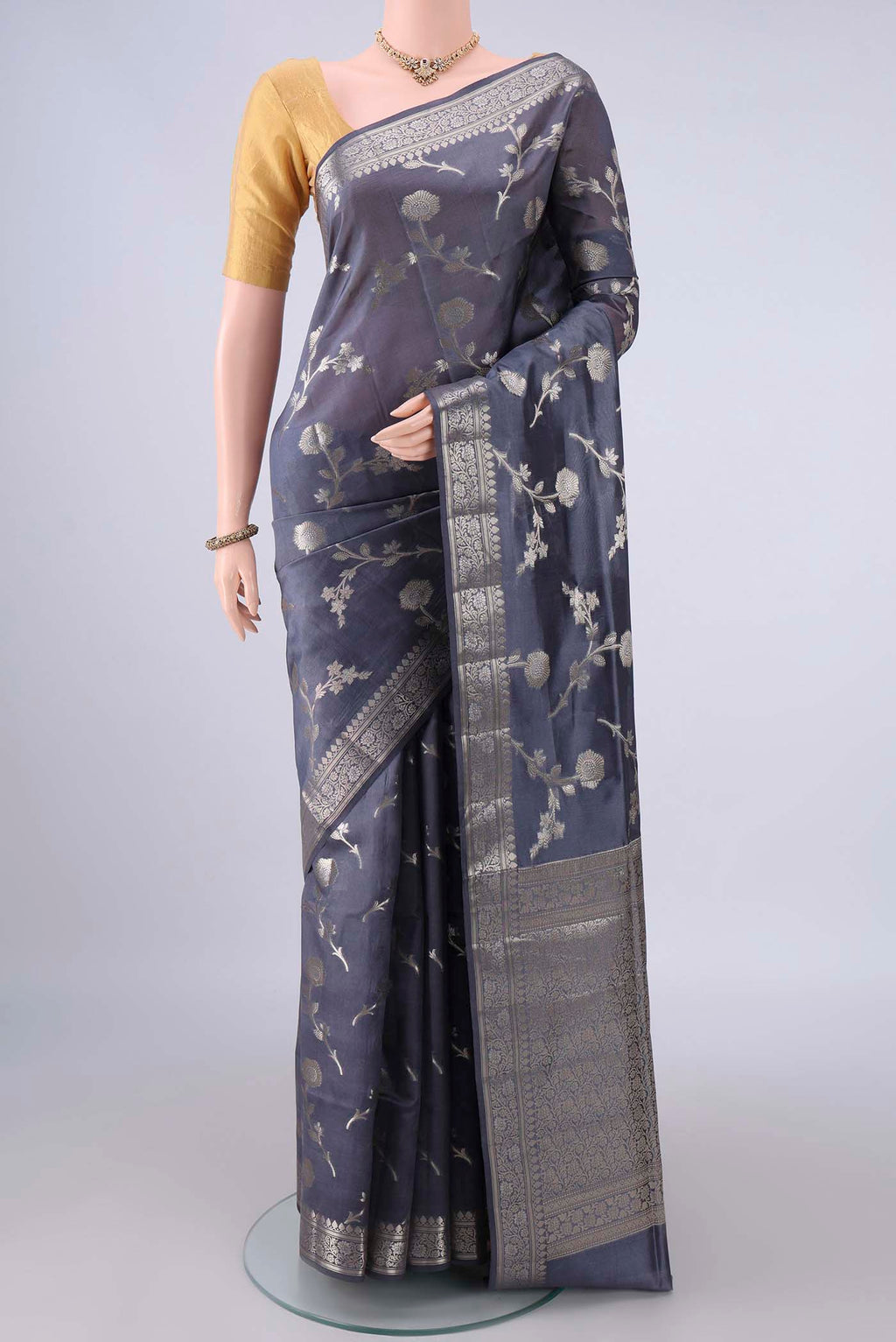 Pure Silk Davys Grey Banarasi Raw Saree with Zari Butta on the body and Zari Border.  displayed on a mannequin