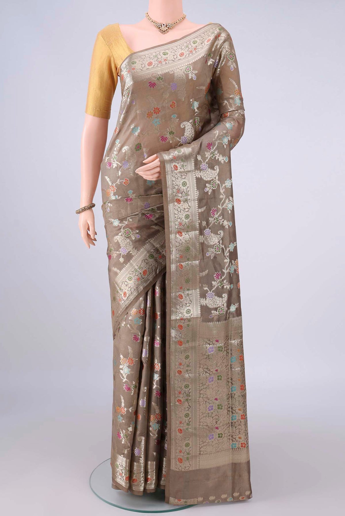 Pure Silk Dark Beige Banarasi Raw Saree with Zari Brocade on the body and Zari And Thread Border.  displayed on a mannequin