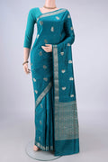 Pure Silk Teal Banarasi Raw Saree with Zari Butta on the body and Zari Border.  displayed on a mannequin