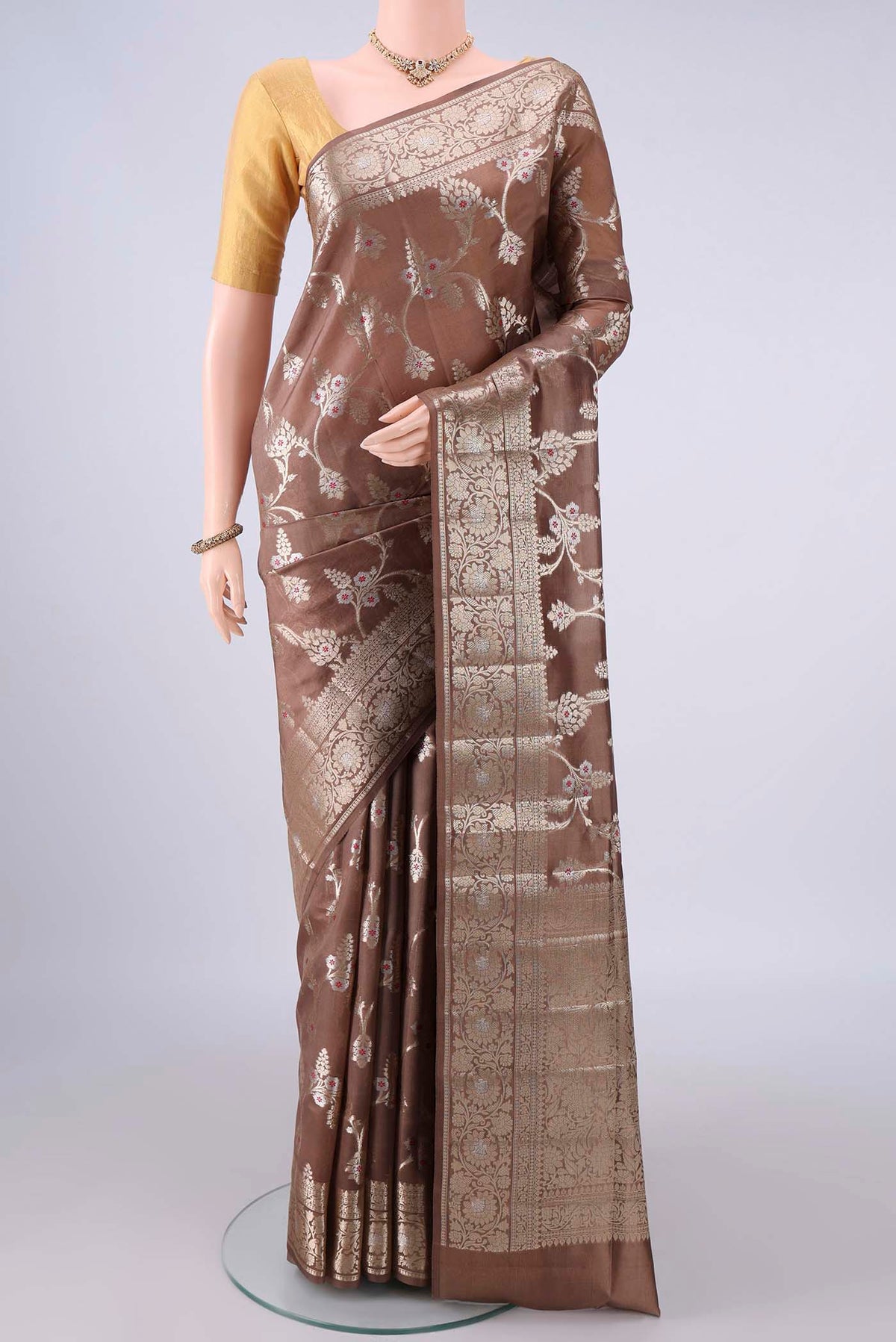 Pure Silk Bronze Banarasi Raw Saree with Zari Butta on the body and Zari Border.  displayed on a mannequin